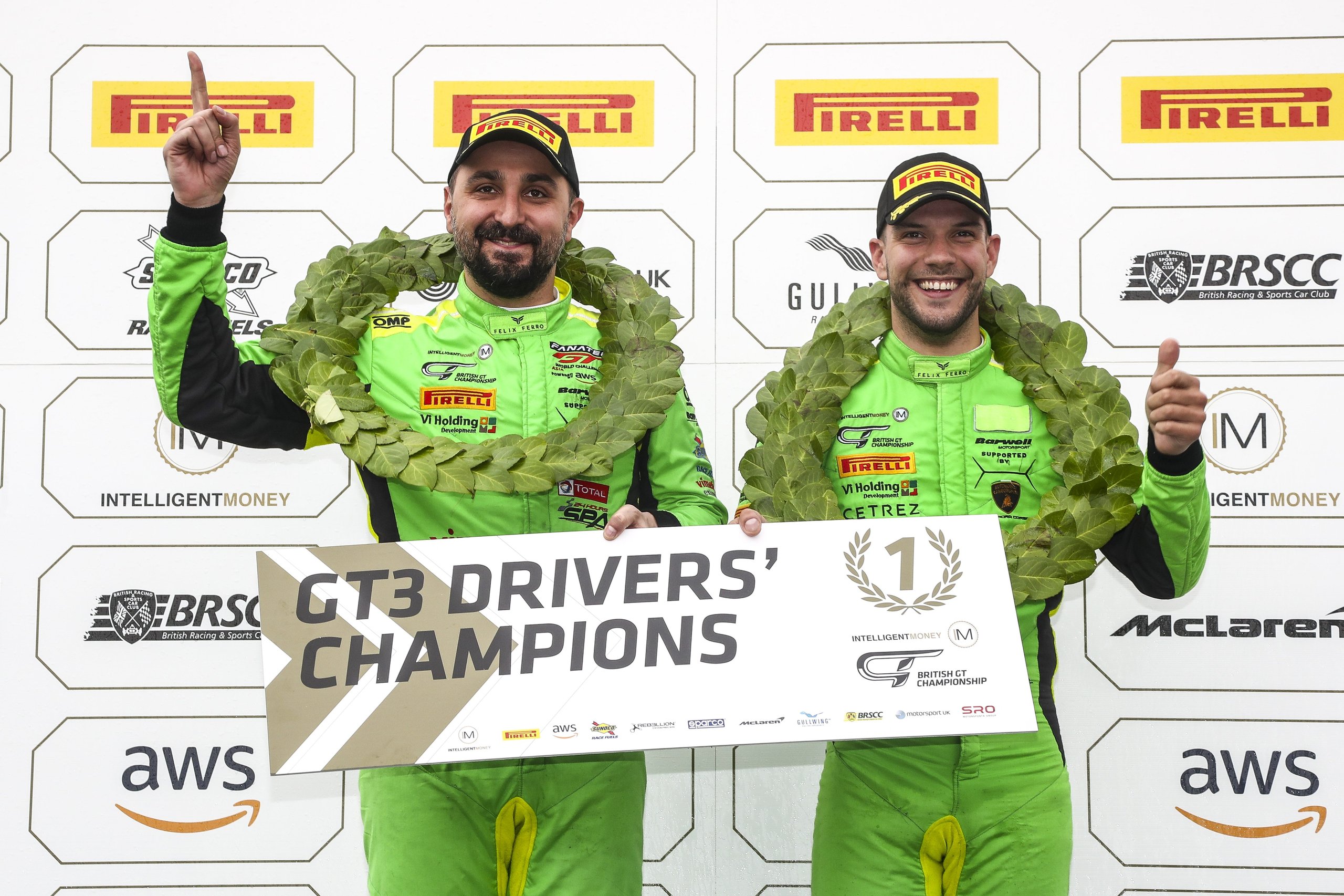 Seven Titles In One Season: What Squadra Corse'S 2021 Sweep Reveals About Lamborghini'S Racing Machine 5 Two racing drivers in green suits and laurel wreaths celebrate their gt3 drivers' championship victory on the podium