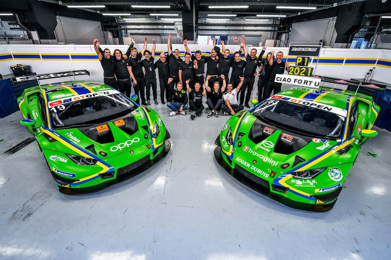 Seven Titles In One Season: What Squadra Corse'S 2021 Sweep Reveals About Lamborghini'S Racing Machine 7 K-pax racing team celebrates in the pit garage alongside two green lamborghini huracán gt3 evo cars with p. 1 2021 signs visible