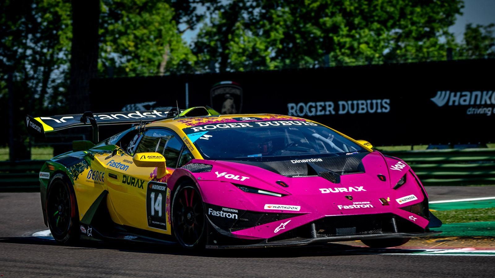 37 Cars, Four Titles Separated By Single Points: Lamborghini Super Trofeo Europe Hits Spa At The Boiling Point 5 Vibrant pink and yellow lamborghini huracán super trofeo evo2 race car with sponsor decals driving on a racetrack