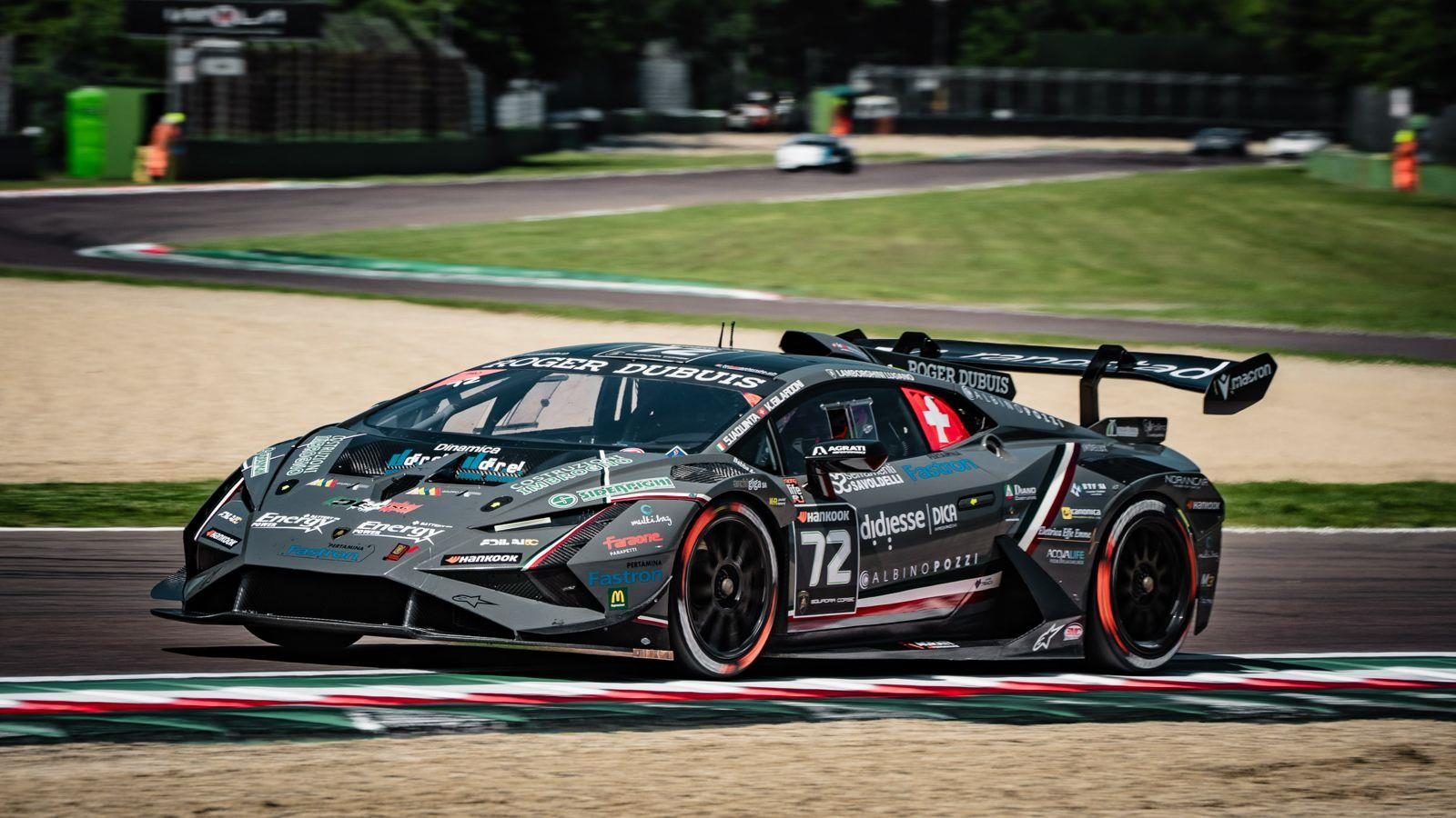 37 Cars, Four Titles Separated By Single Points: Lamborghini Super Trofeo Europe Hits Spa At The Boiling Point 7 Grey lamborghini huracán super trofeo evo2 race car with orange accents speeding around a corner on a racetrack