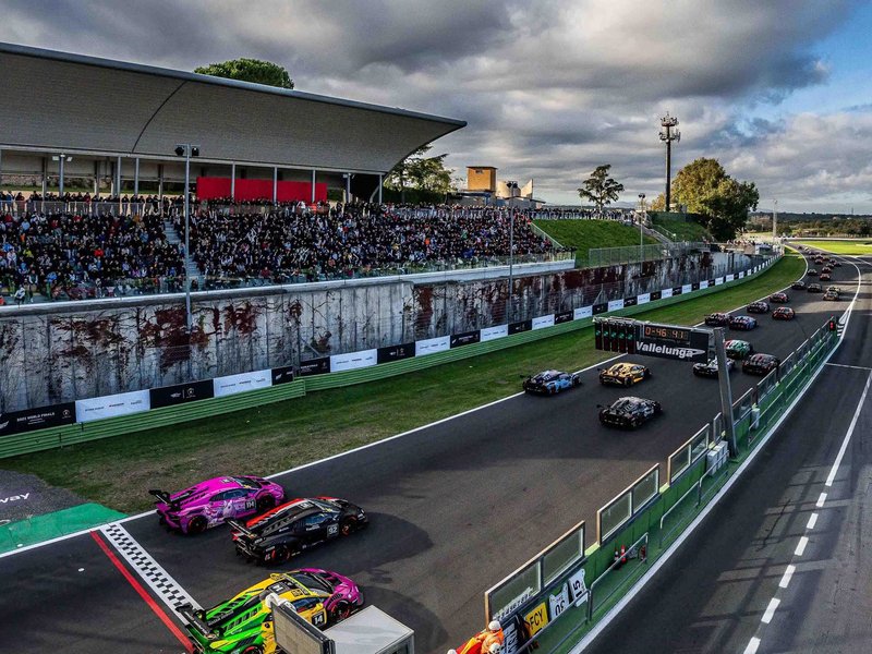 Multiple Lamborghini Huracán Super Trofeo race cars on track at Vallelunga with spectators in the grandstands