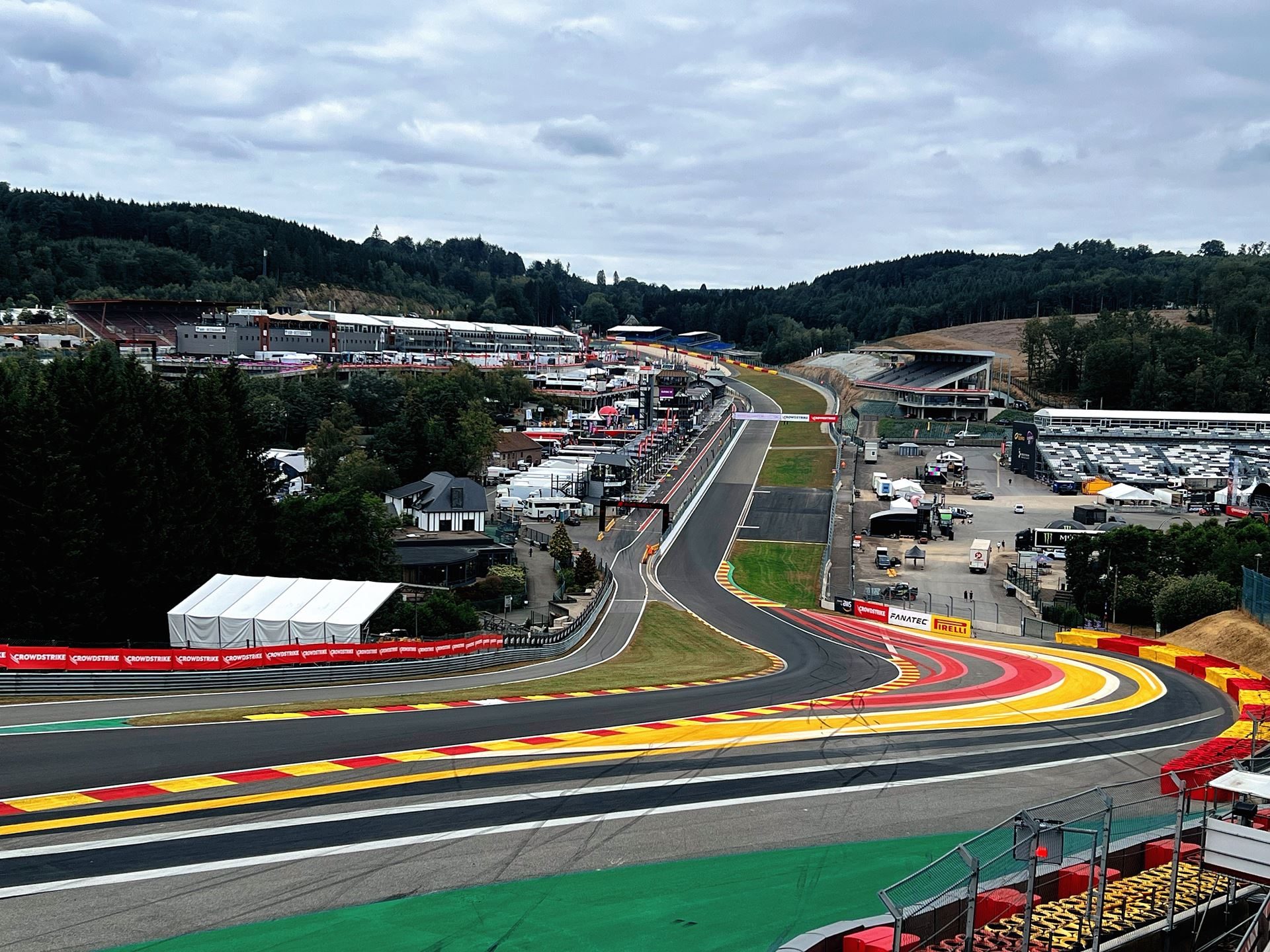 49 Huracán Evo2S At Spa: Lamborghini'S One-Make Series Celebrates 60 Years Where It All Began 3 Expansive view of the spa-francorchamps circuit showing elevation changes, turns, and spectator stands under an overcast sky