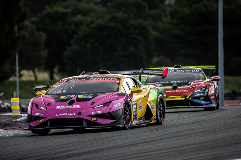 Two Lamborghini Huracán Super Trofeo EVO2 race cars in colorful liveries battling side-by-side on track