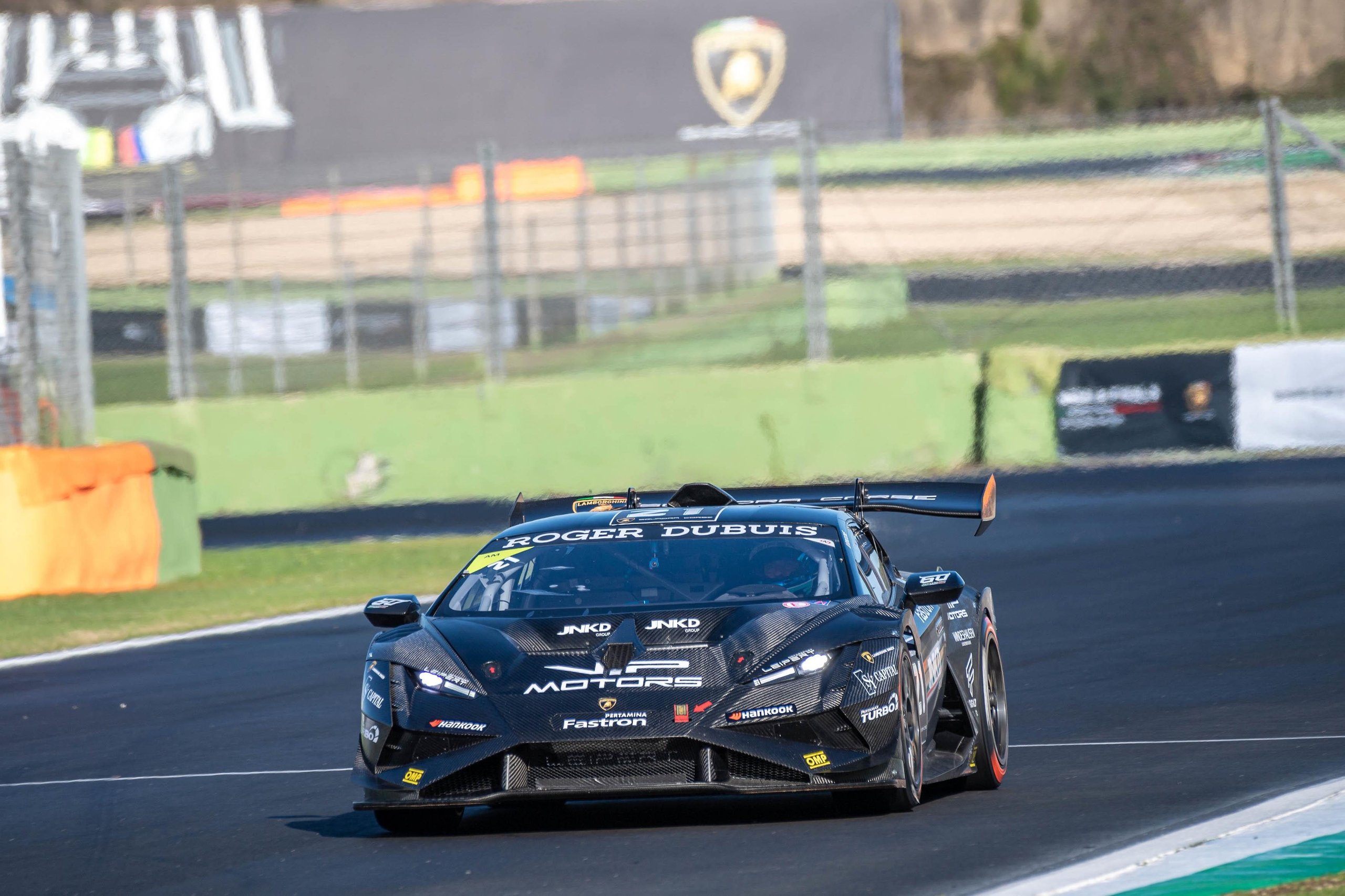 Leitch Claims European Pro Title In Thrilling Lamborghini Super Trofeo Finale That Crowned Champions Across Three Continents 3 Black lamborghini huracán super trofeo evo2 with red and white sponsor decals cornering hard on a racetrack