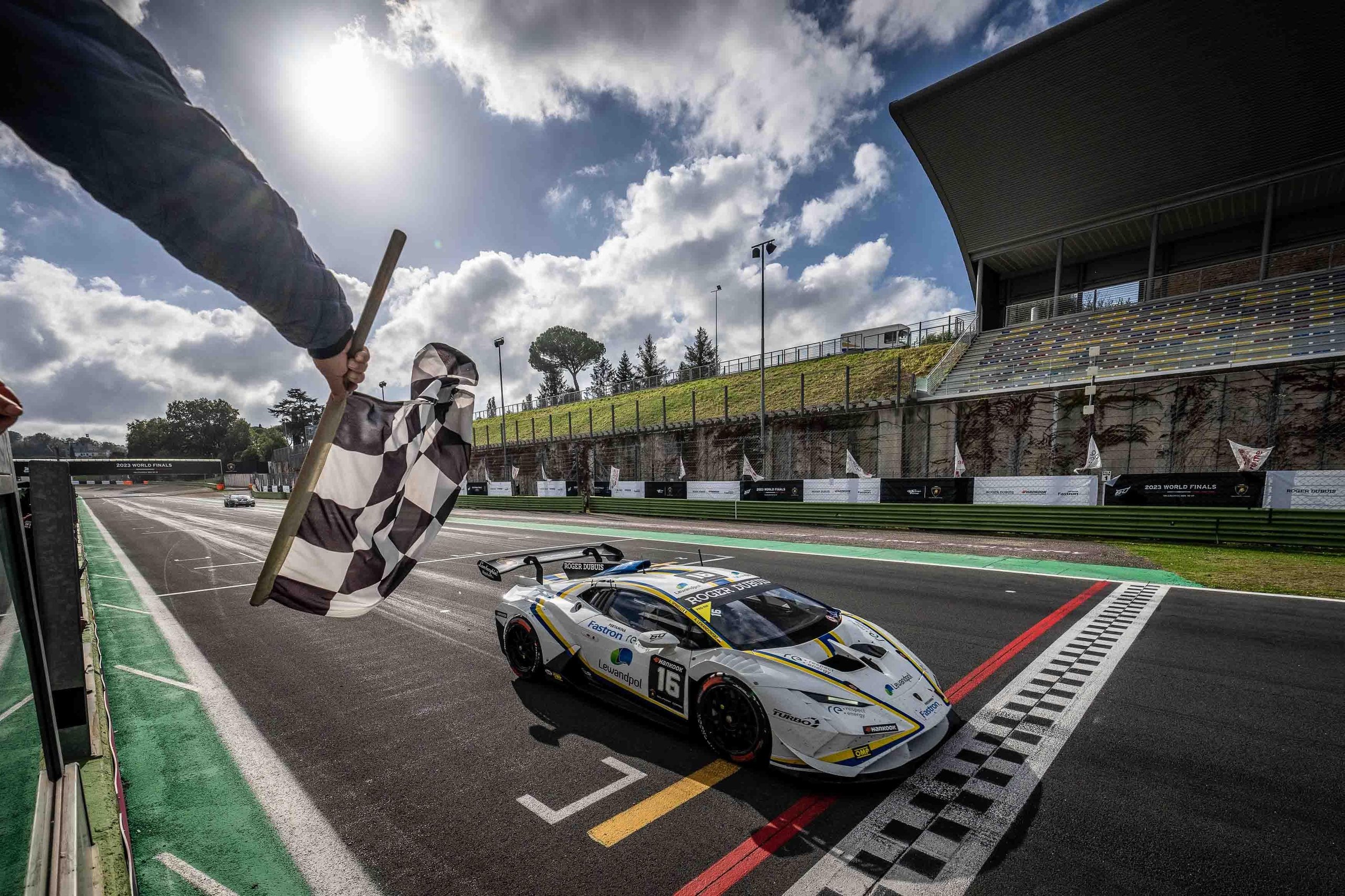 Leitch Claims European Pro Title In Thrilling Lamborghini Super Trofeo Finale That Crowned Champions Across Three Continents 5 White lamborghini huracán super trofeo evo2 crossing the finish line under a checkered flag at vallelunga