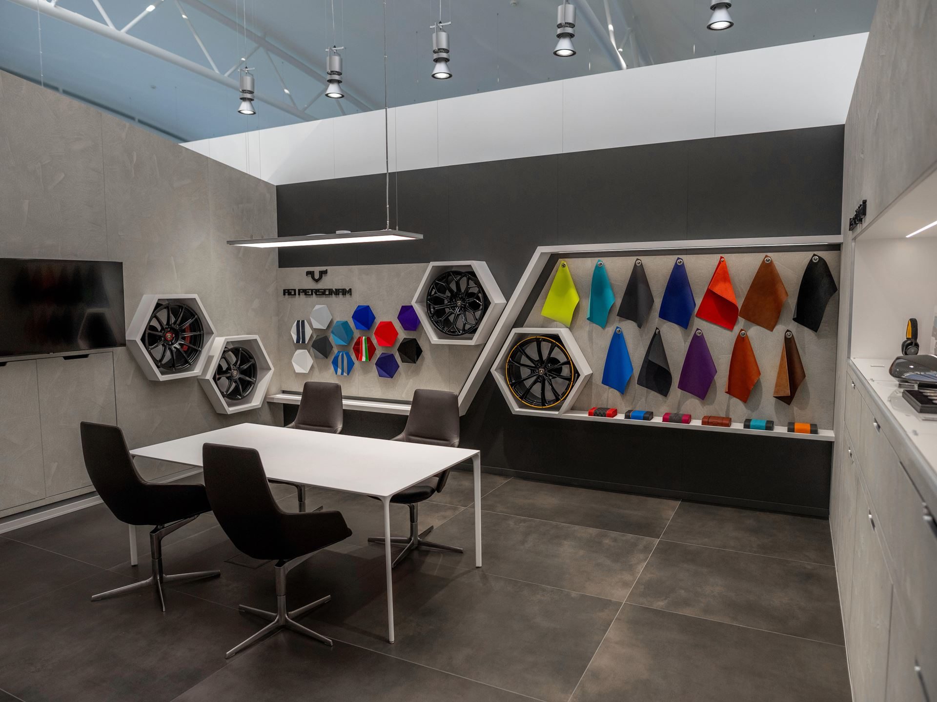 Lamborghini Tallinn'S New Showroom Pairs A Choir, A Diablo, And The Urus Se To Sell Its Hybrid Future 7 Interior of the lamborghini ad personam studio in tallinn showing wheel options, paint swatches, and leather samples on display