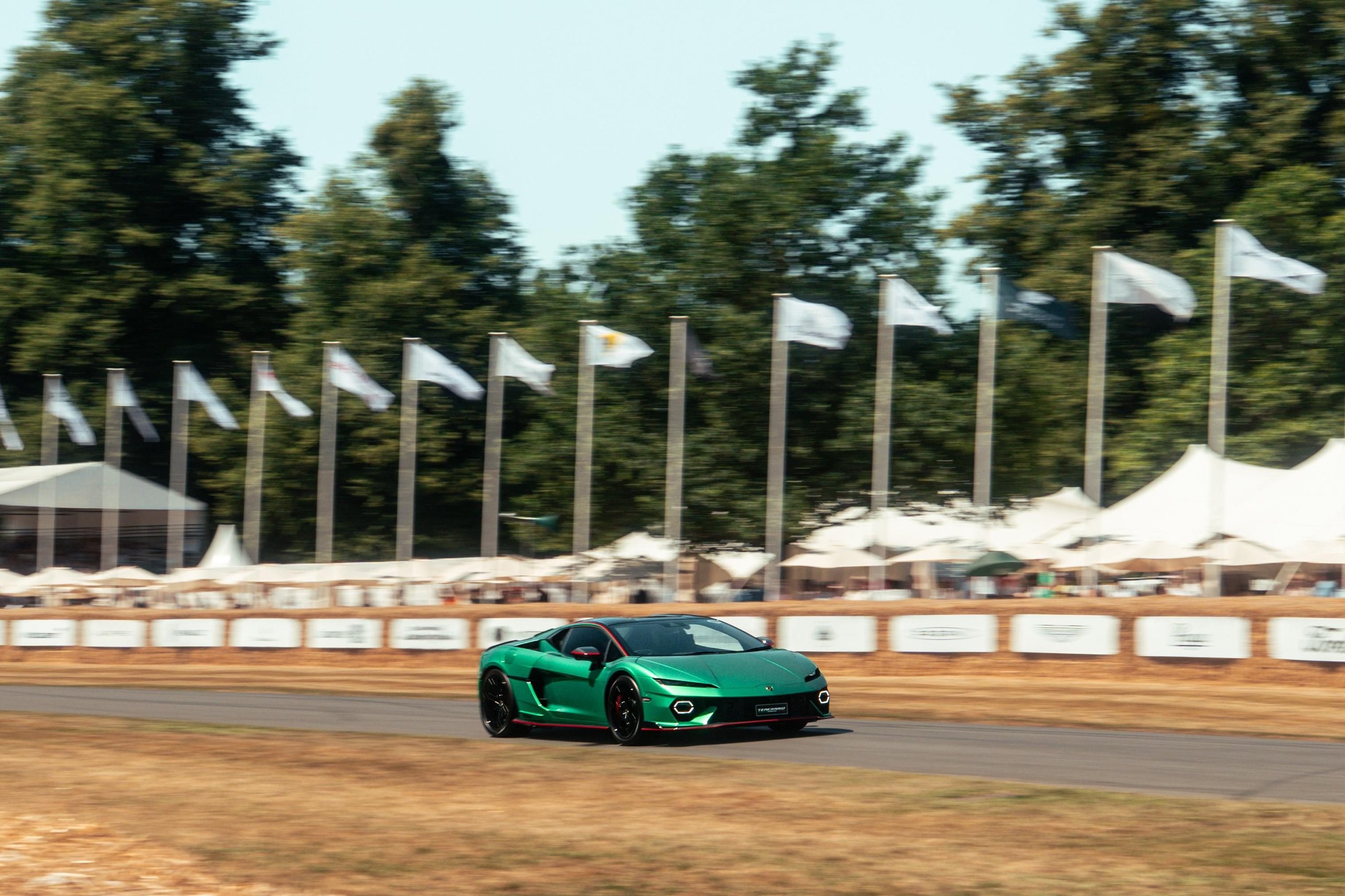 Lamborghini temerario gt3 in tricolore livery driving toward the camera on the goodwood hill climb, front splitter and air intakes visible