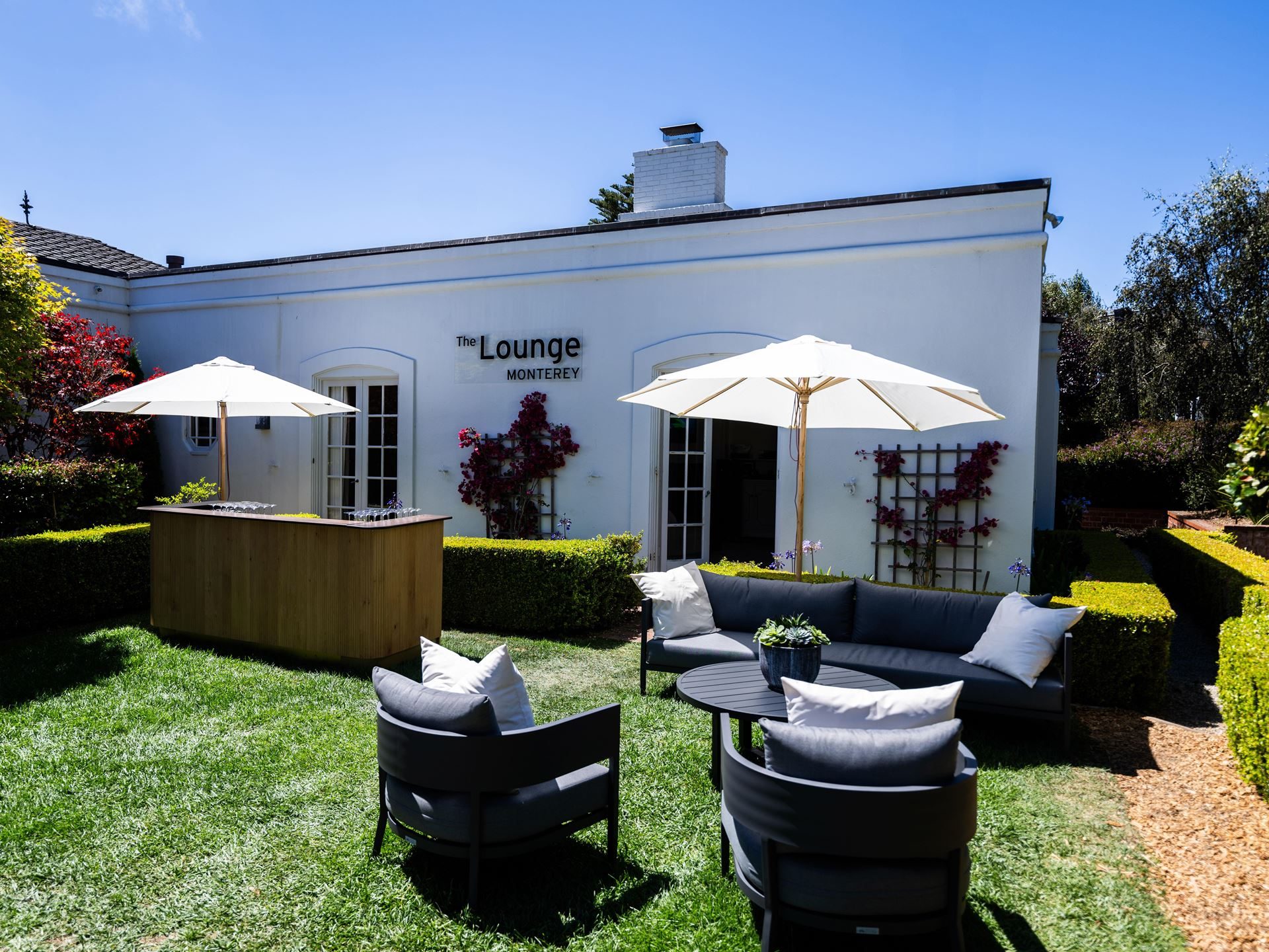 Lamborghini Staged Its Hybrid Future Around The Temerario At Monterey Car Week 3 Outdoor lounge area with modern furniture and white umbrellas at the lamborghini lounge monterey