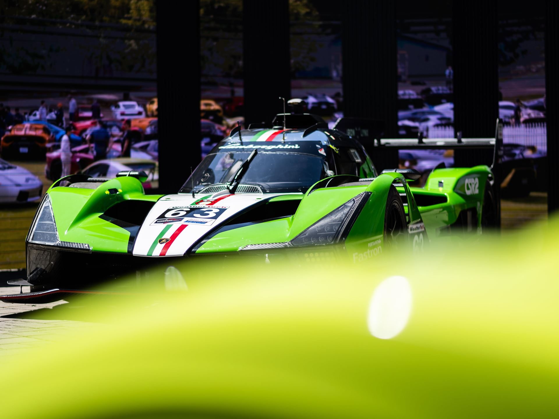 Lamborghini Staged Its Hybrid Future Around The Temerario At Monterey Car Week 7 Front view of the green, white, and red lamborghini sc63 lmdh hybrid race car on display at monterey