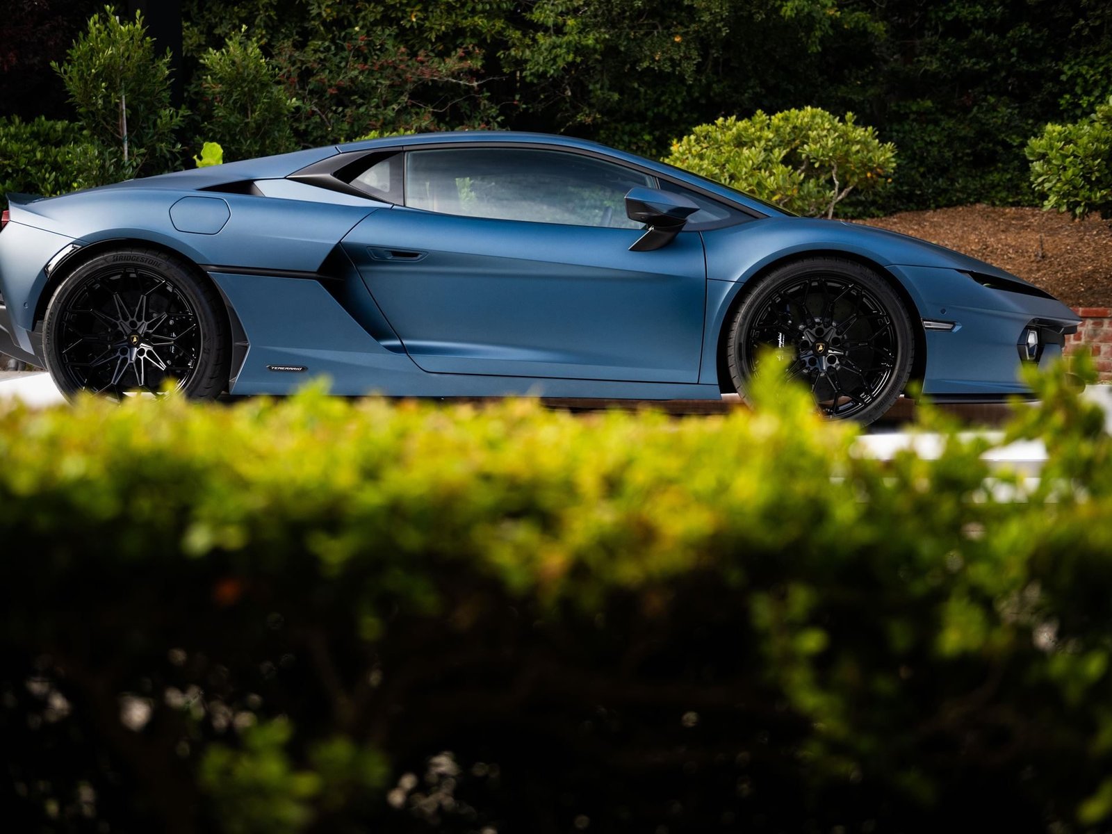 Matte blue Lamborghini Temerario in side profile at Monterey Car Week 2024