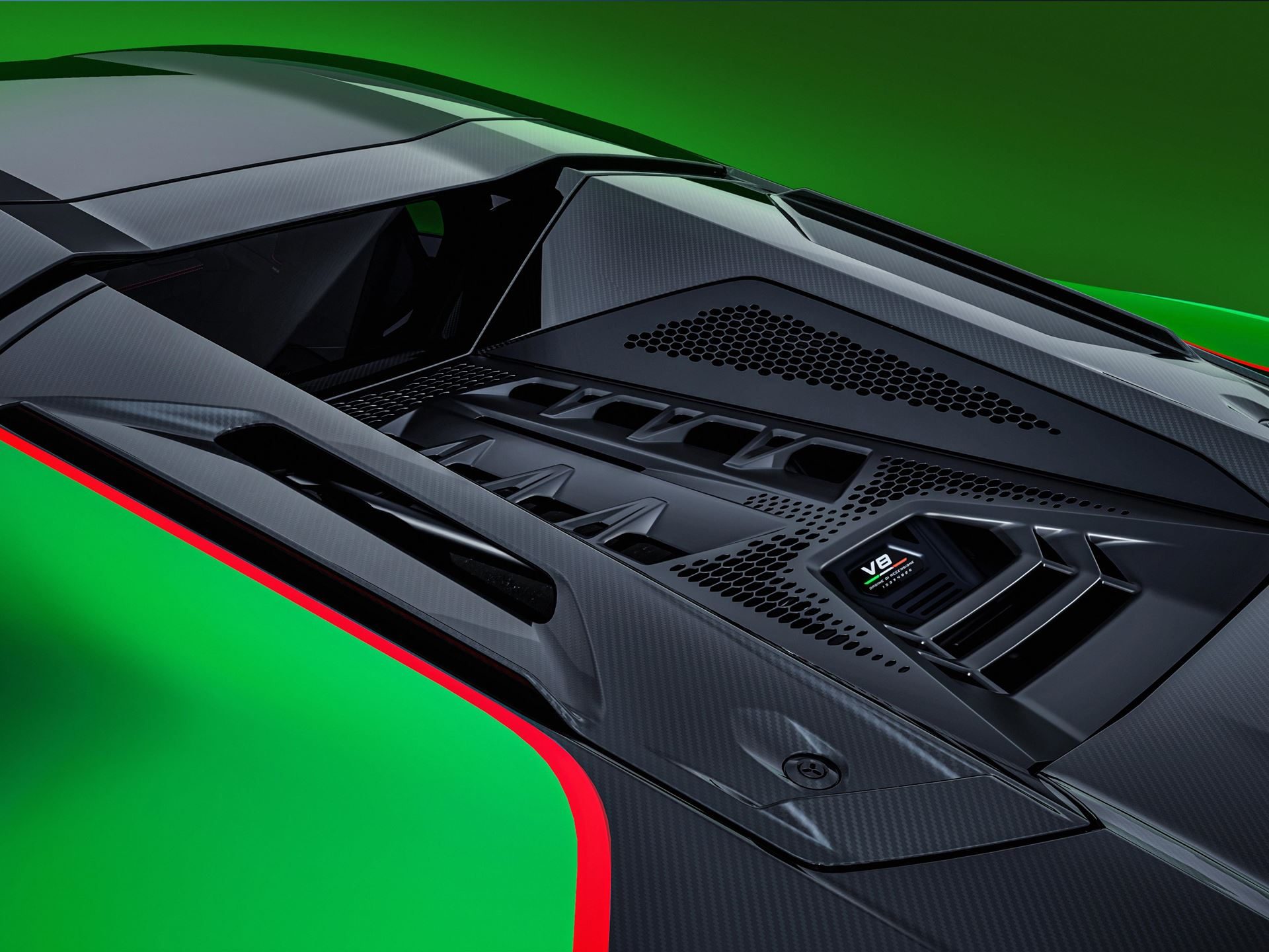 Top-down close-up of the lamborghini temerario engine bay showing carbon fiber, vents, and v8 hybrid badge