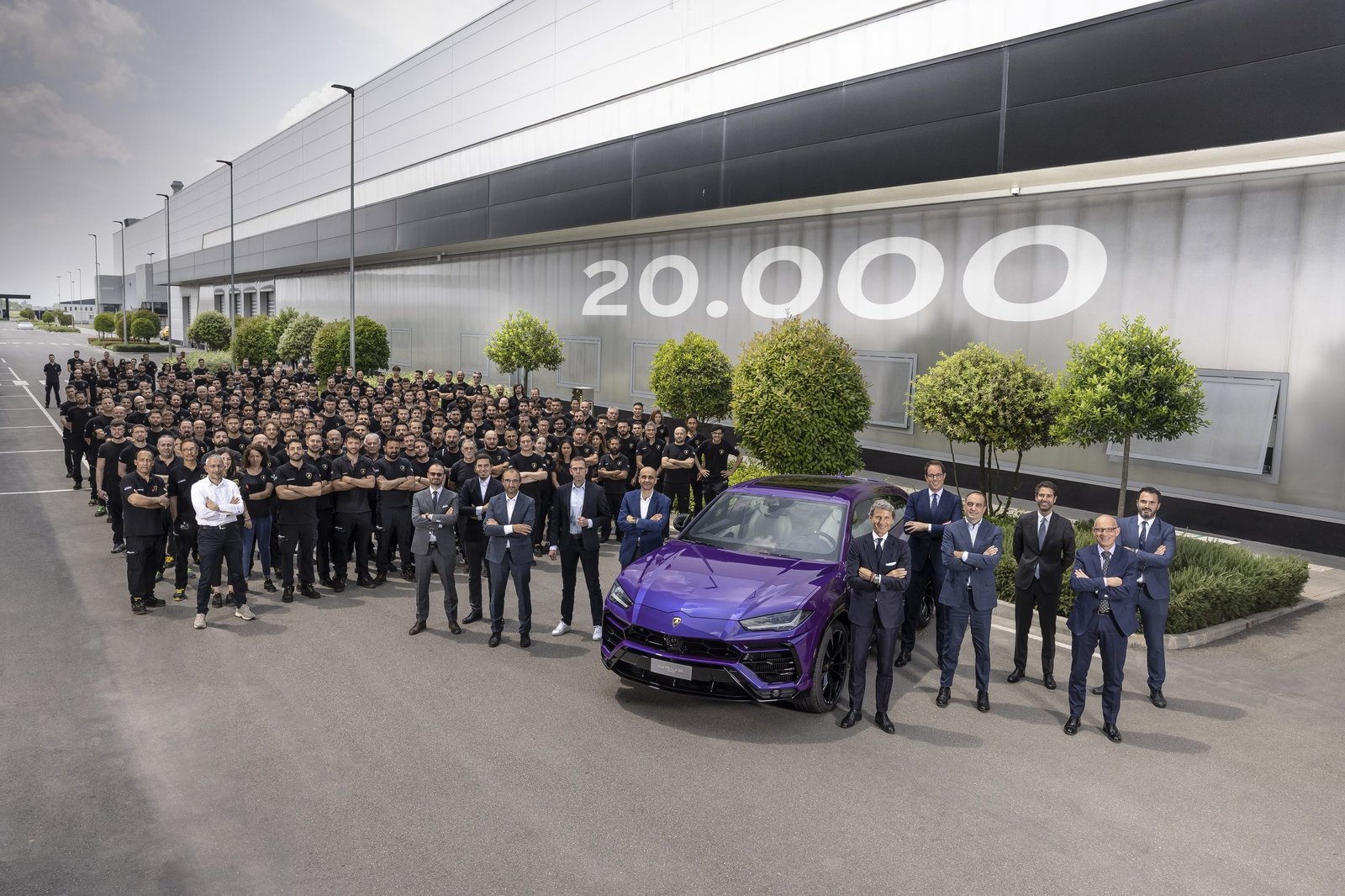 Lamborghini employees celebrate around the 20,000th Urus in Viola Mithras at the Sant'Agata Bolognese factory
