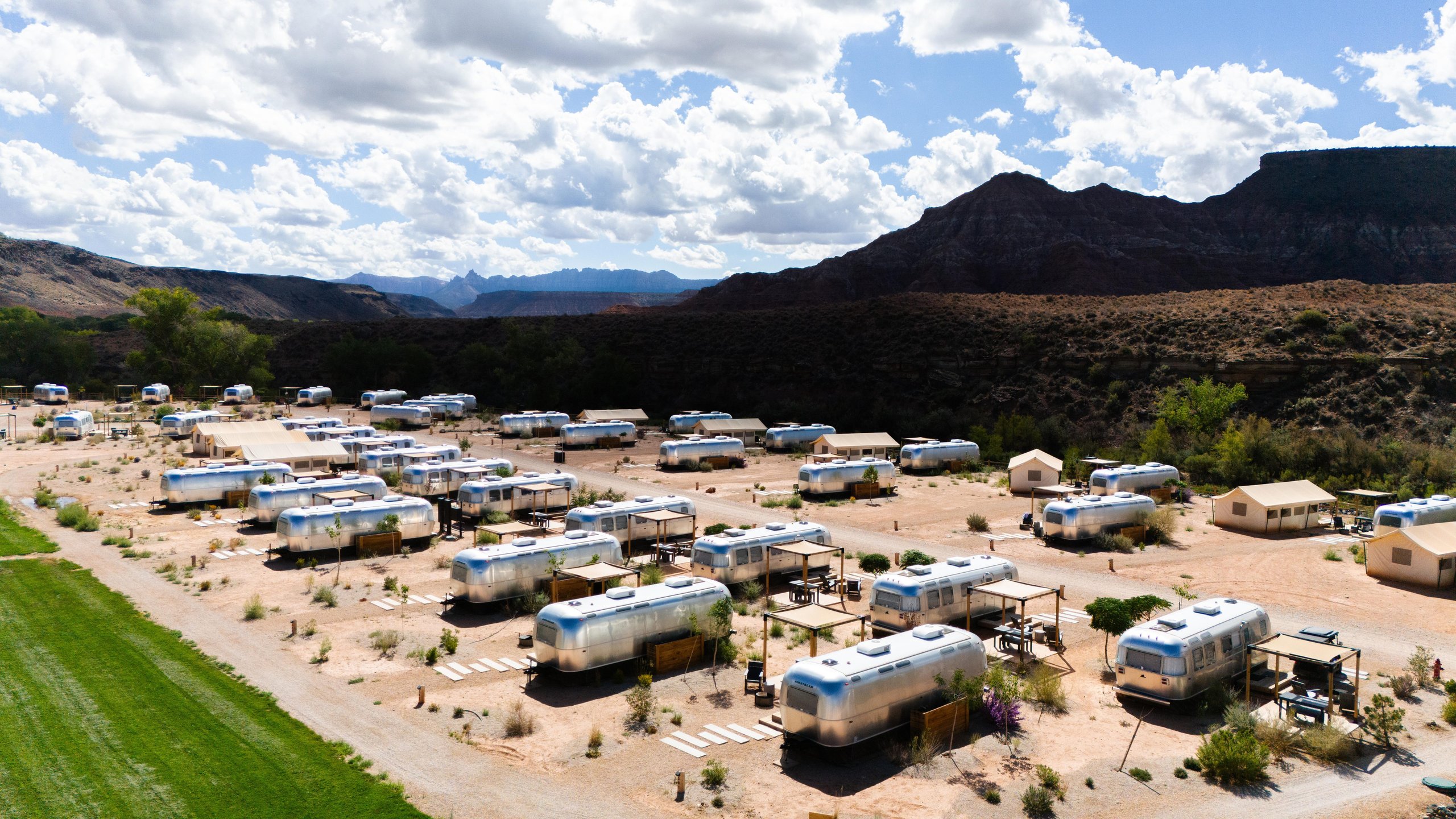 Lamborghini Sent A Convoy Of Urus Ses Into Zion'S Desert. The Real Destination Was Brand Loyalty. 5 Aerial view of autocamp zion glamping site with silver airstream trailers surrounded by desert landscape and red rock mountains