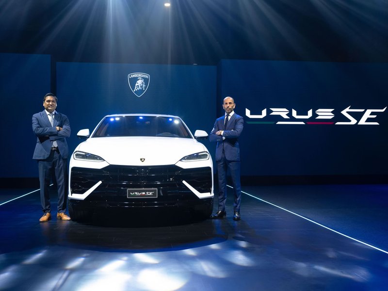 White Lamborghini Urus SE on stage at the India launch event with Lamborghini and Urus SE branding on screens behind it