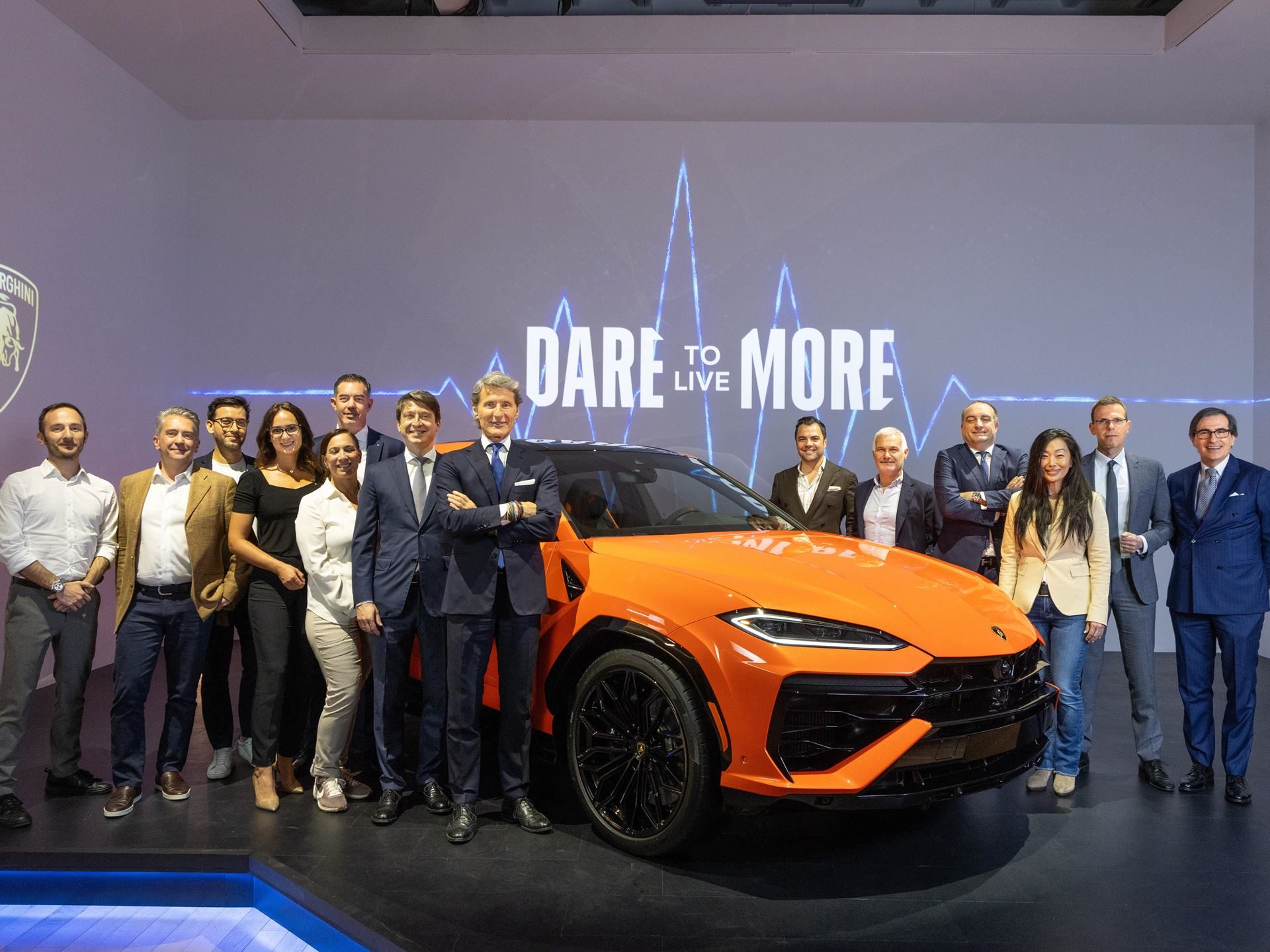 Lamborghini Brings The 789-Hp Urus Se To New York, Betting Its Best-Seller On Hybrid Power 7 Lamborghini executives and team members pose with the urus se at the nyc premiere event with dare to live more backdrop
