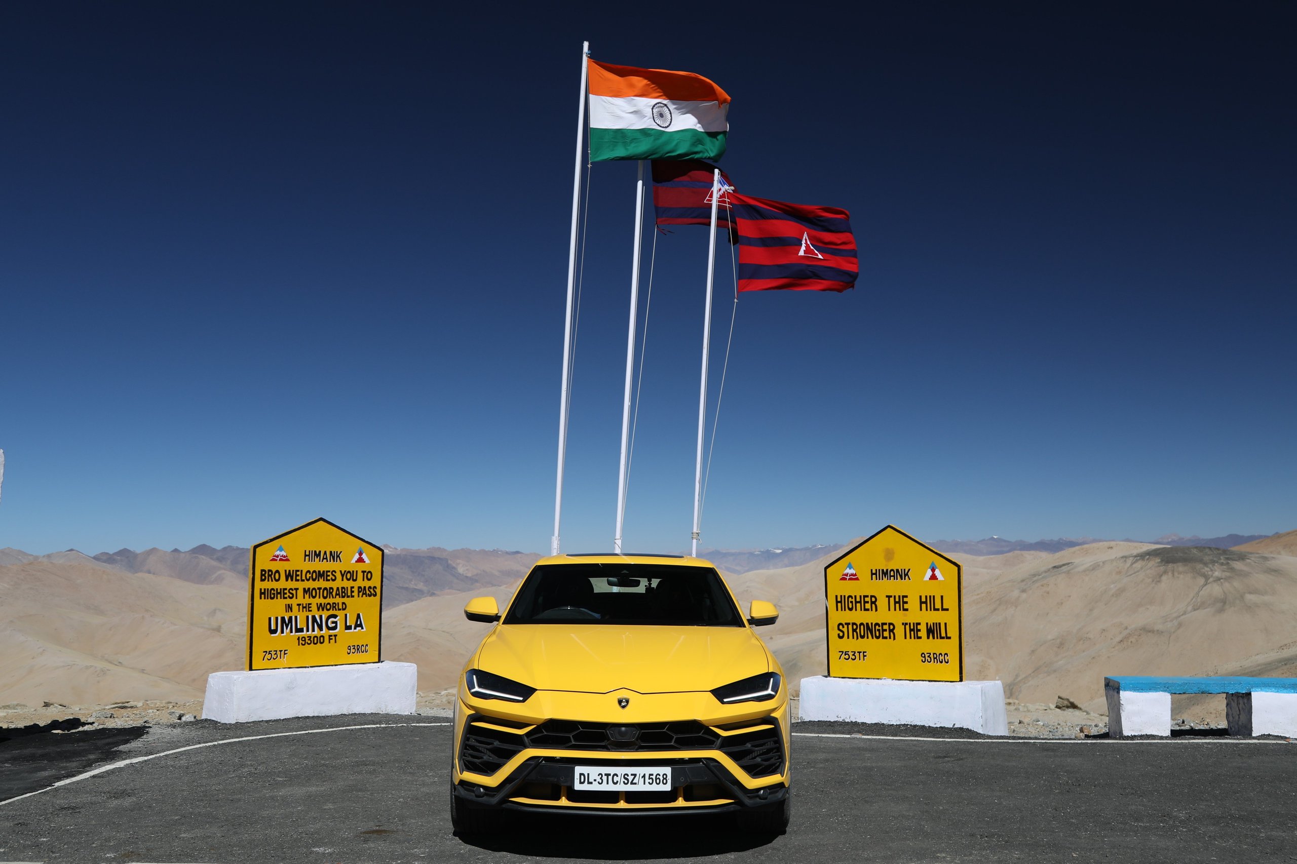 The Lamborghini Urus At 19,300 Feet: Conquering The World'S Highest Drivable Road 7 Yellow lamborghini urus parked at the umling la mountain pass with signs and indian flag