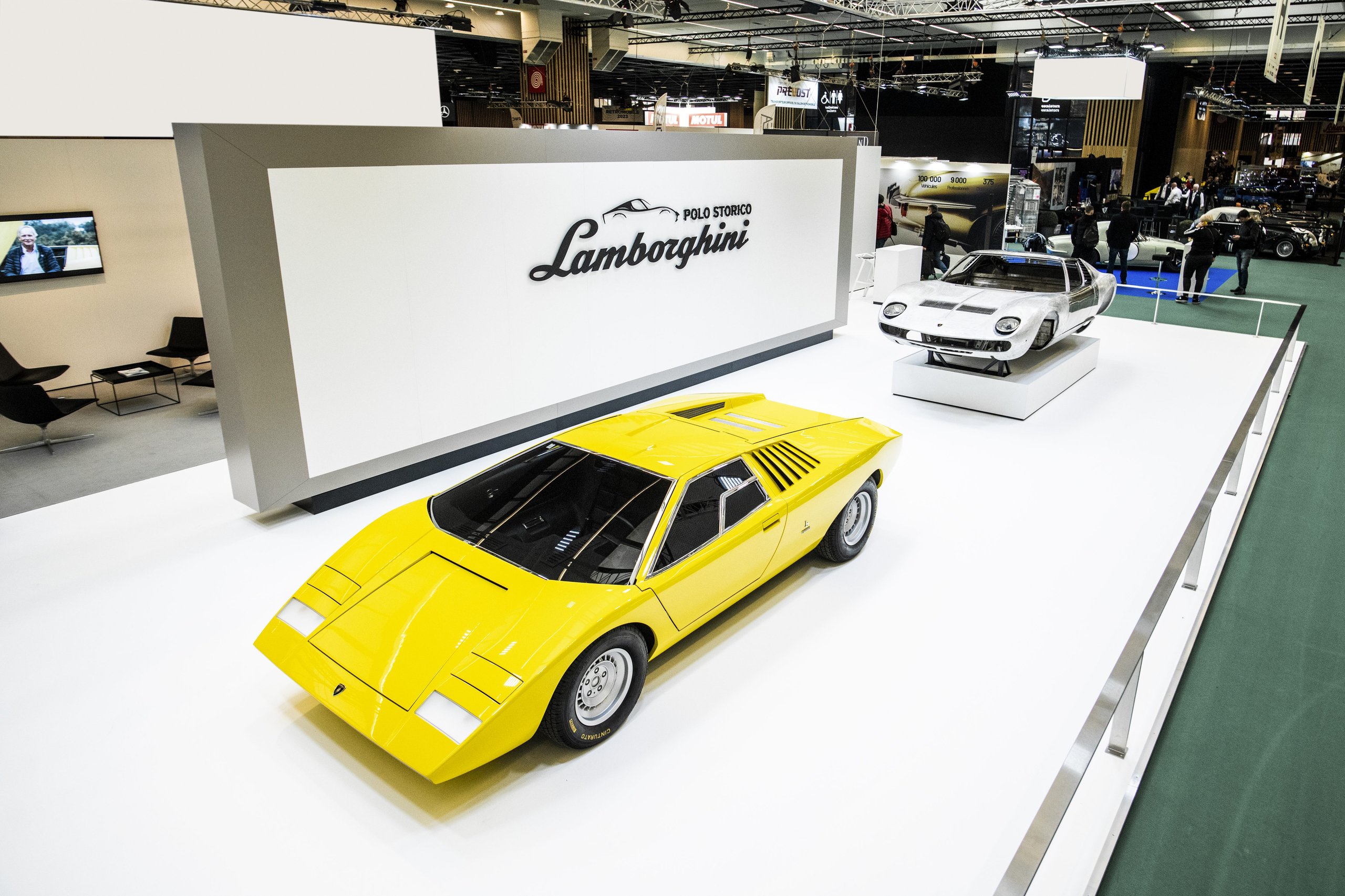 25,000 Hours To Build A Bridge: How Polo Storico'S Resurrected Countach Lp 500 Frames Lamborghini'S Hybrid V12 Future 3 Overhead view of lamborghini polo storico stand at rétromobile featuring yellow countach lp 500 and bare miura sv chassis