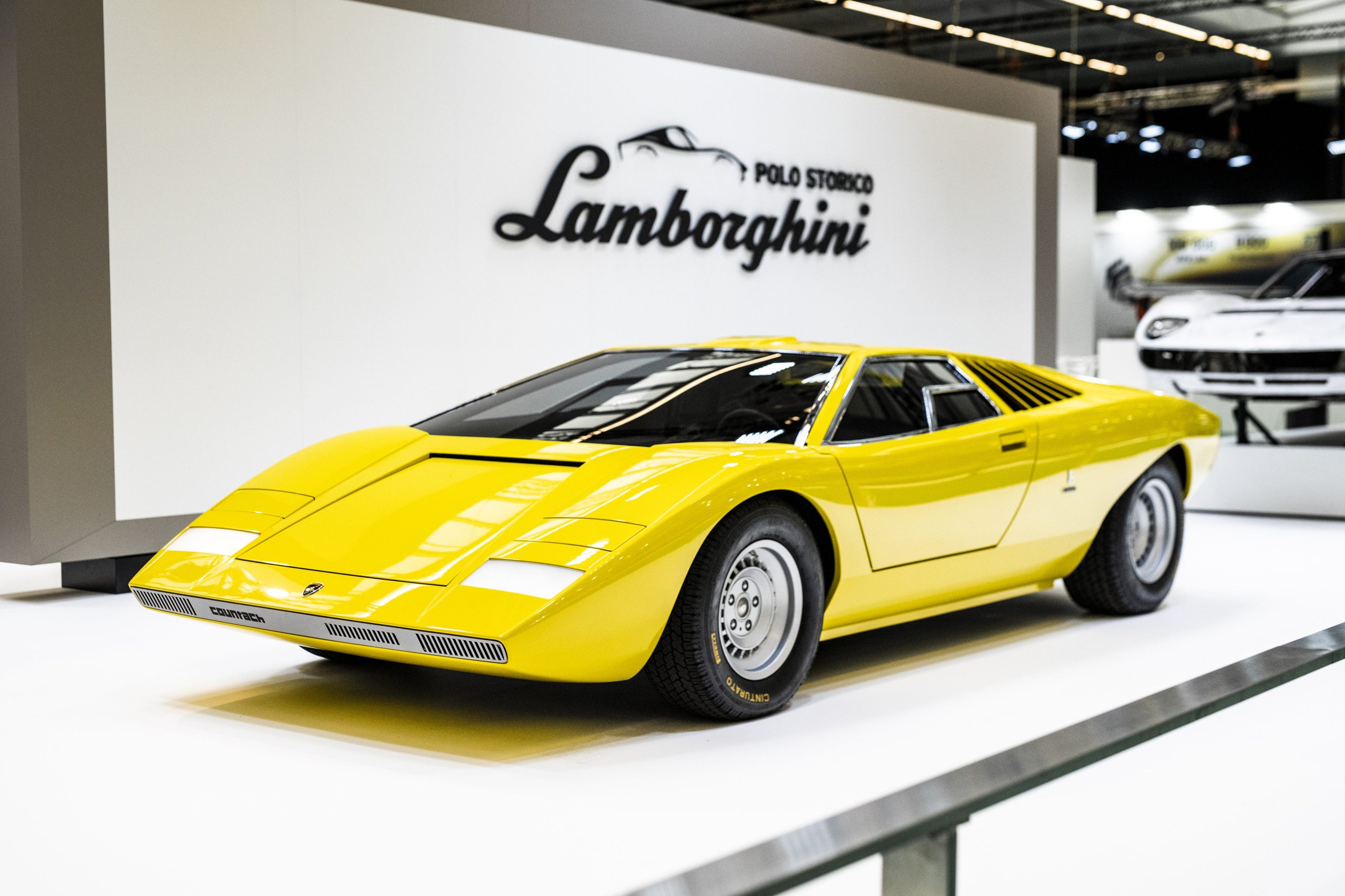 25,000 Hours To Build A Bridge: How Polo Storico'S Resurrected Countach Lp 500 Frames Lamborghini'S Hybrid V12 Future 5 Reconstructed yellow lamborghini countach lp 500 prototype on display at rétromobile with polo storico branding