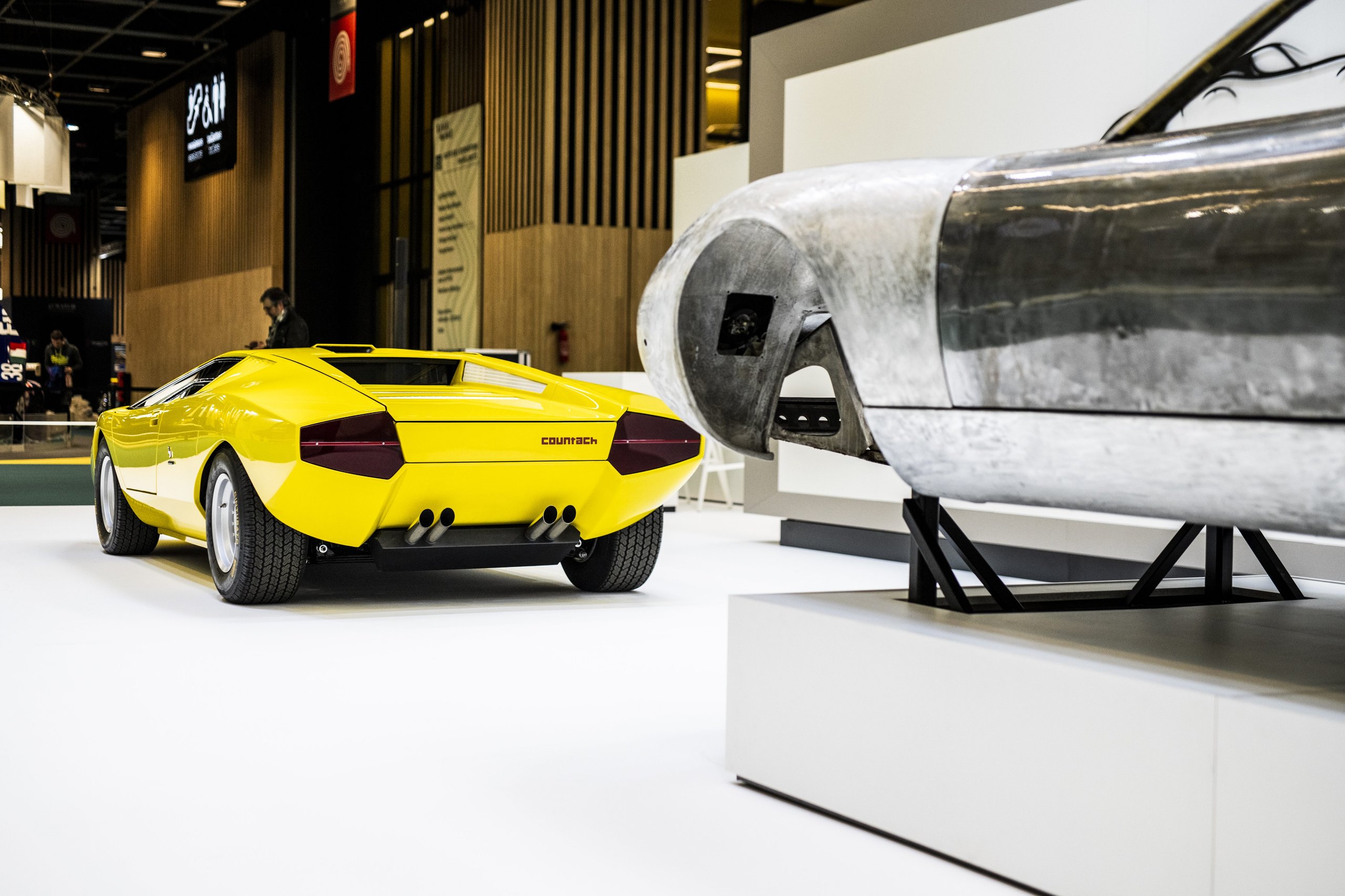 25,000 Hours To Build A Bridge: How Polo Storico'S Resurrected Countach Lp 500 Frames Lamborghini'S Hybrid V12 Future 11 Rear of yellow countach lp 500 prototype with bare miura p400 sv body visible in background at rétromobile
