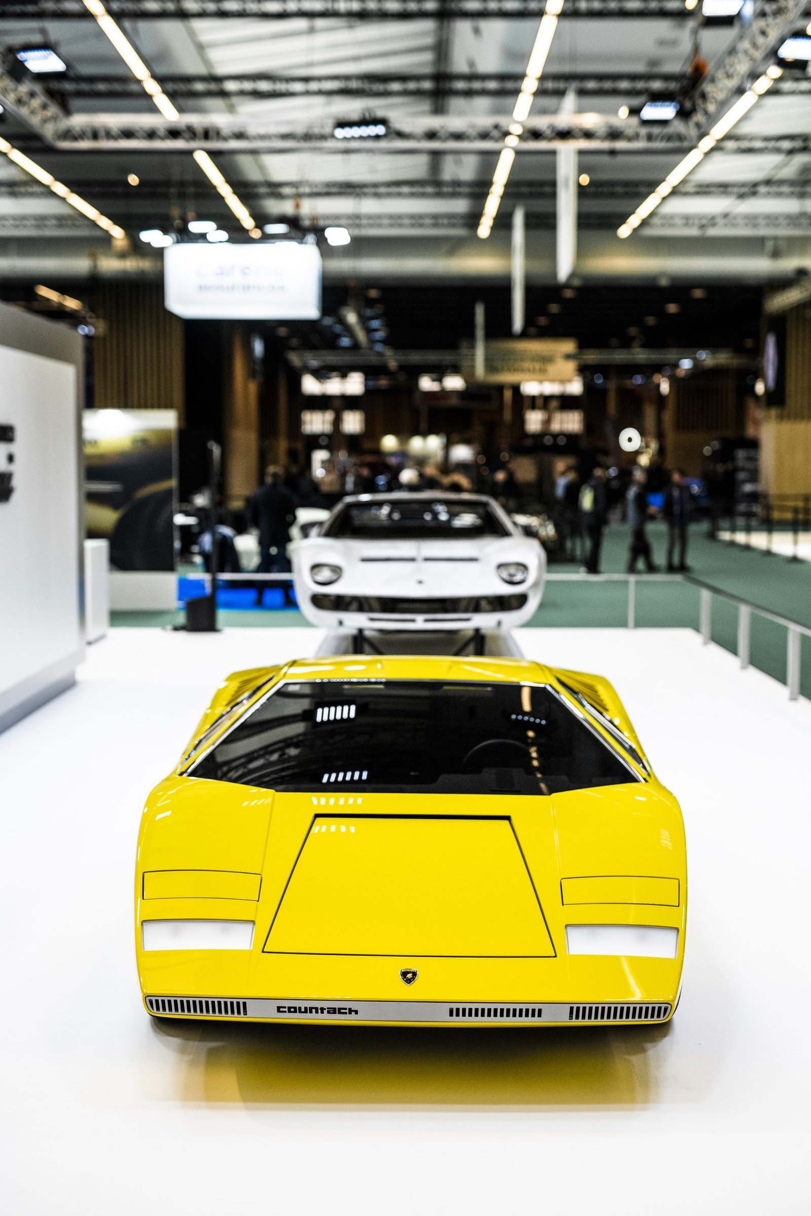 Yellow Lamborghini Countach LP 500 prototype alongside white Countach LPI 800-4 at Rétromobile 2022