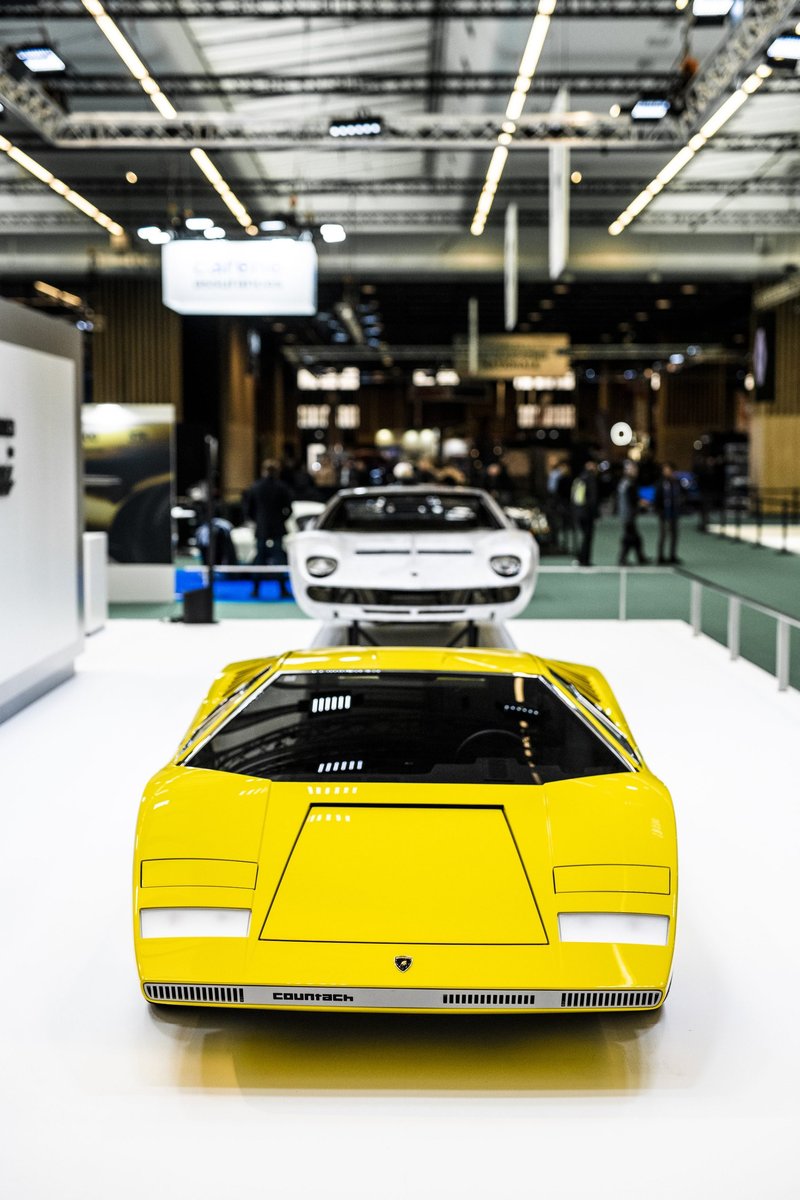 Yellow Lamborghini Countach LP 500 prototype alongside white Countach LPI 800-4 at Rétromobile 2022