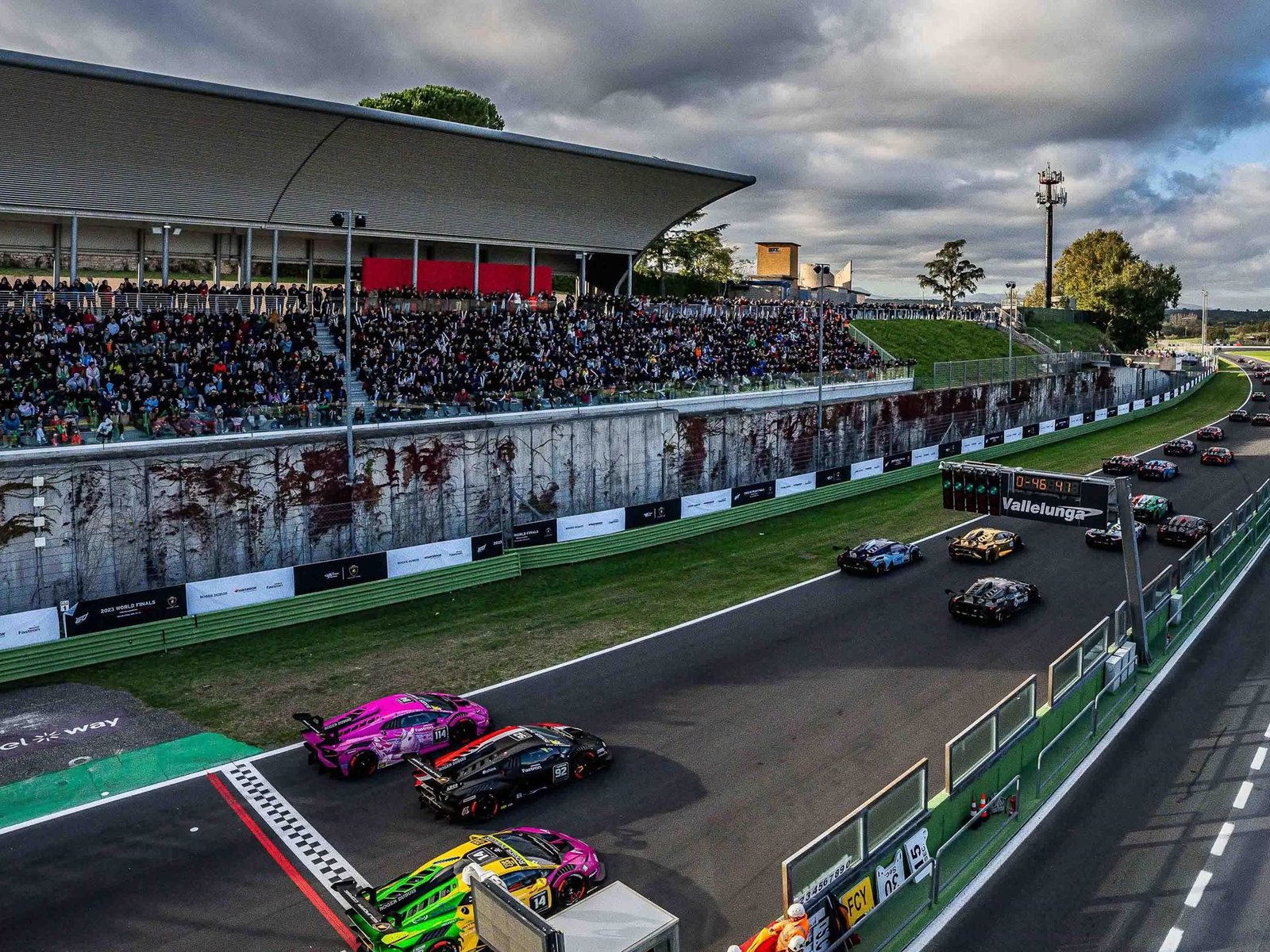 Lamborghini Huracán Super Trofeo EVO2 race cars lined up on the Vallelunga starting grid with packed grandstands behind them