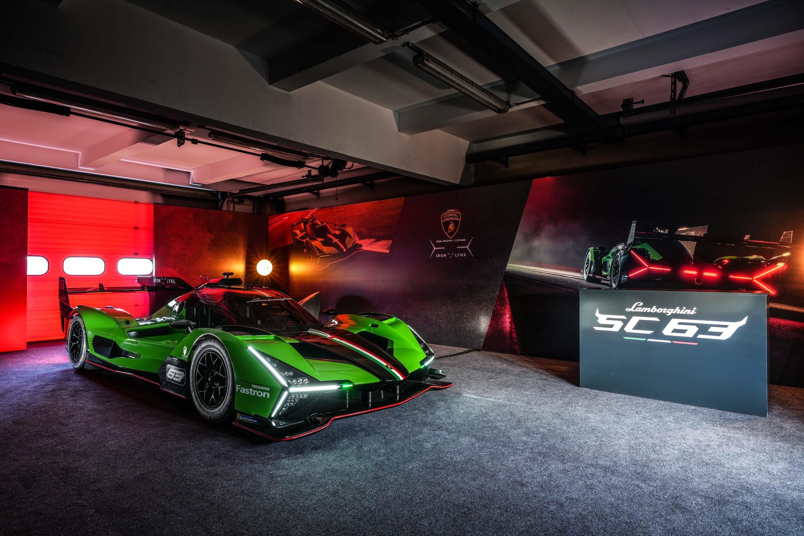 Lamborghini sc63 lmdh prototype displayed under dramatic red accent lighting with sc63 branding