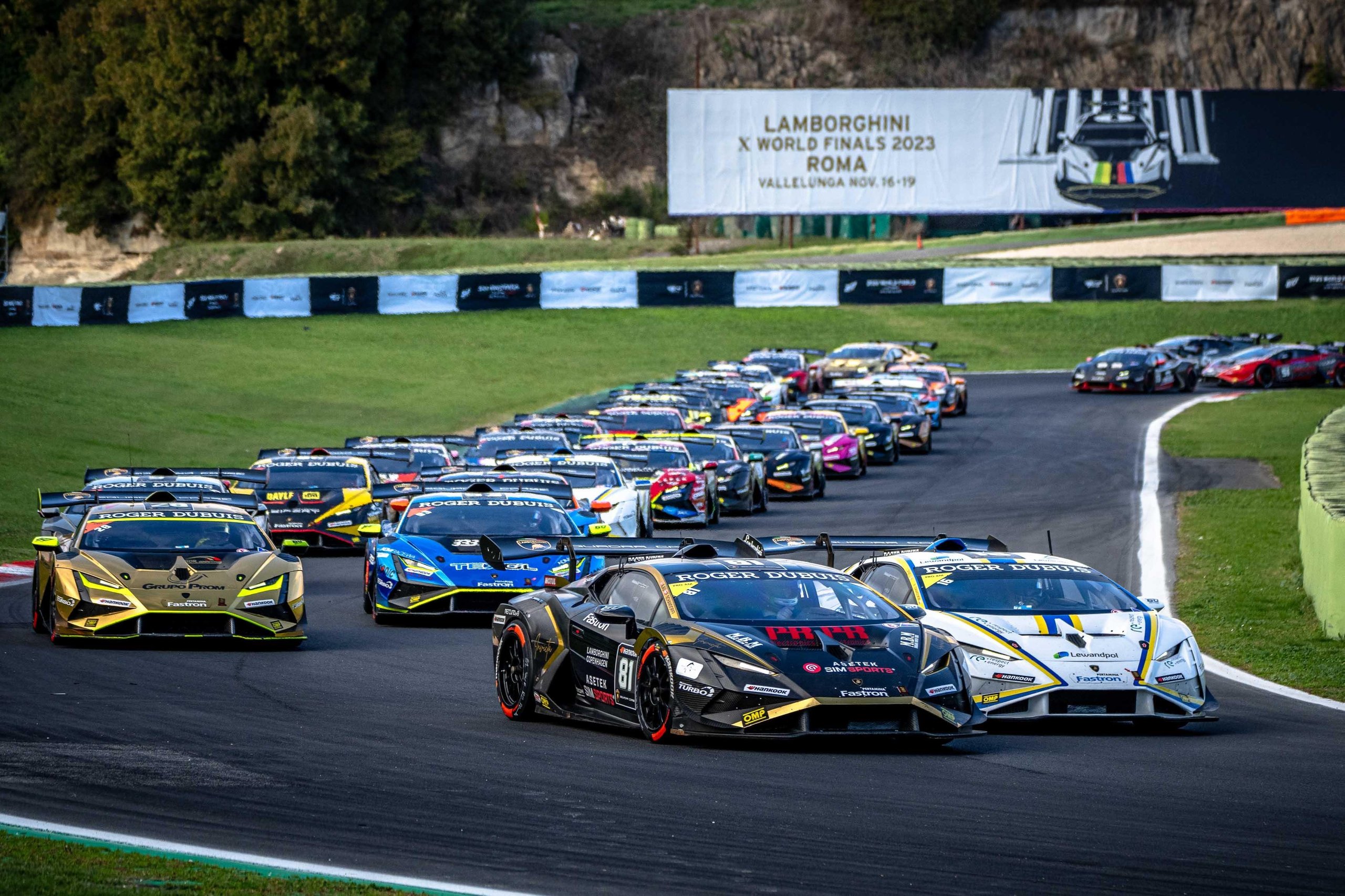 Lamborghini'S World Finals Earned A Sustainability Certification Most Motorsport Events Don'T Bother Pursuing 7 Line of lamborghini huracán super trofeo evo2 race cars on the vallelunga racetrack with event banner visible