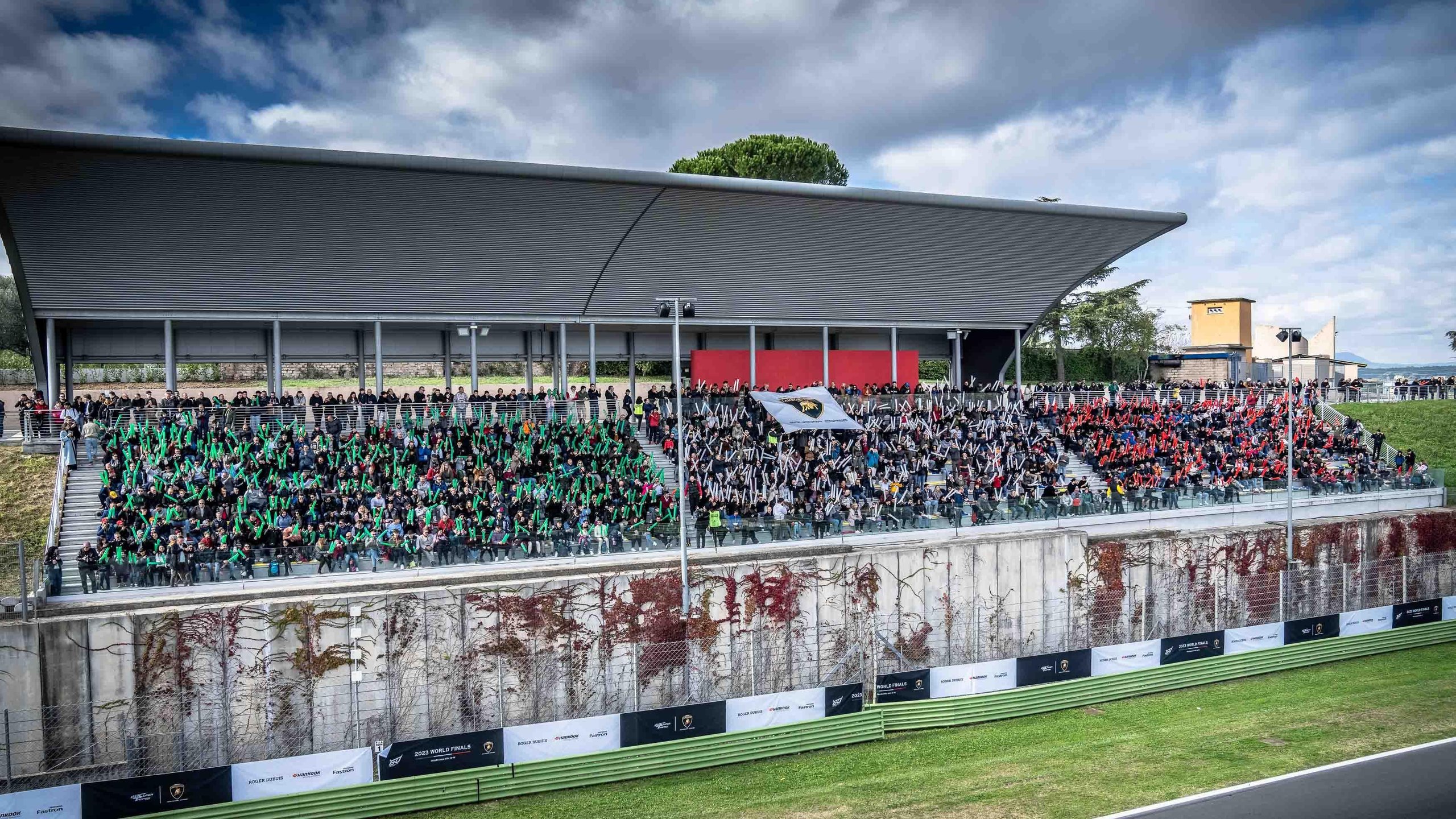 Lamborghini'S World Finals Earned A Sustainability Certification Most Motorsport Events Don'T Bother Pursuing 9 Packed grandstand of spectators holding a lamborghini banner overlooking the vallelunga racetrack