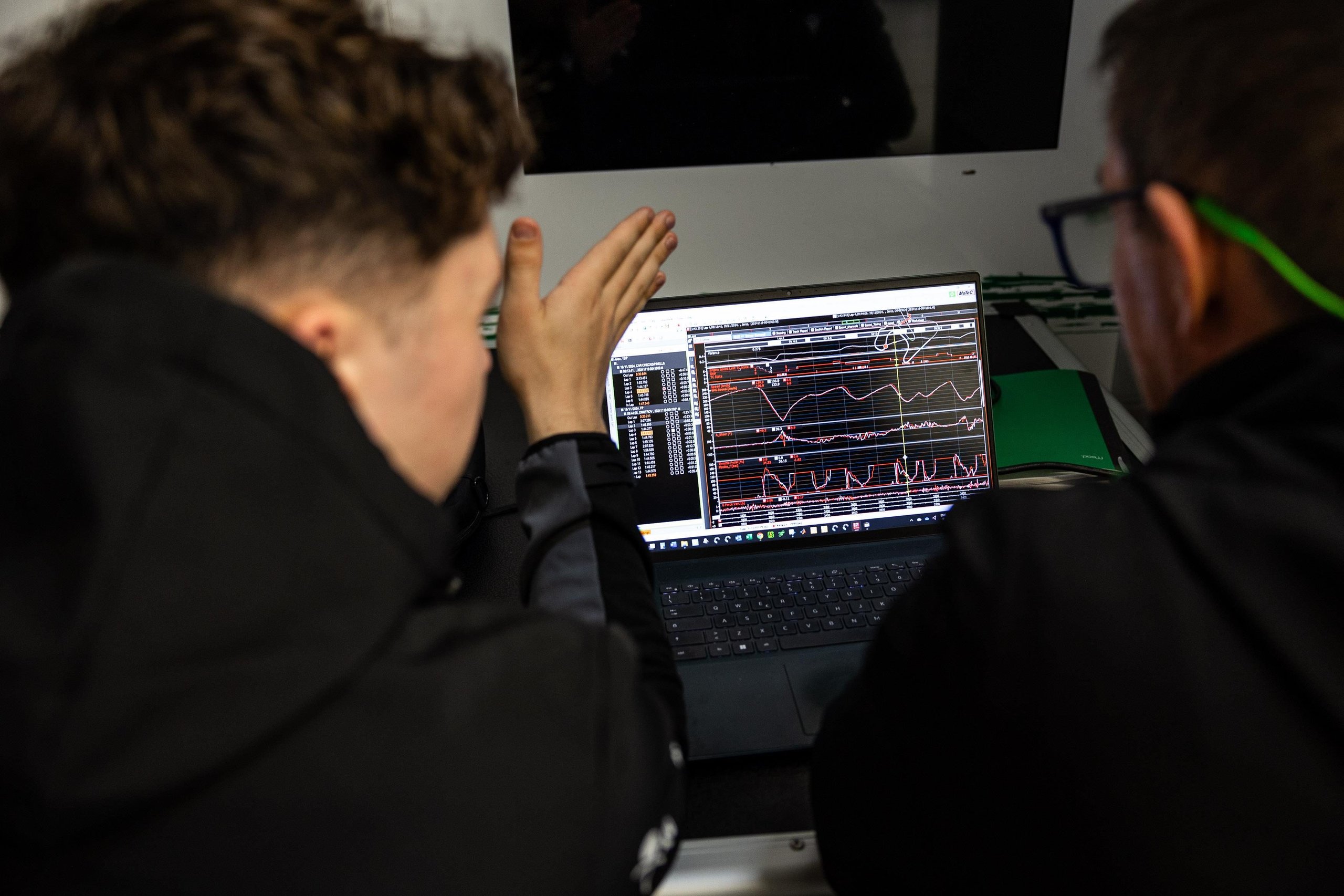 Squadra Corse Rewrites Its Talent Playbook: 26 Drivers Enter Lamborghini'S Merit-Based Pipeline For 2025 3 Two individuals analyzing performance data and graphs on a laptop screen at a lamborghini squadra corse event