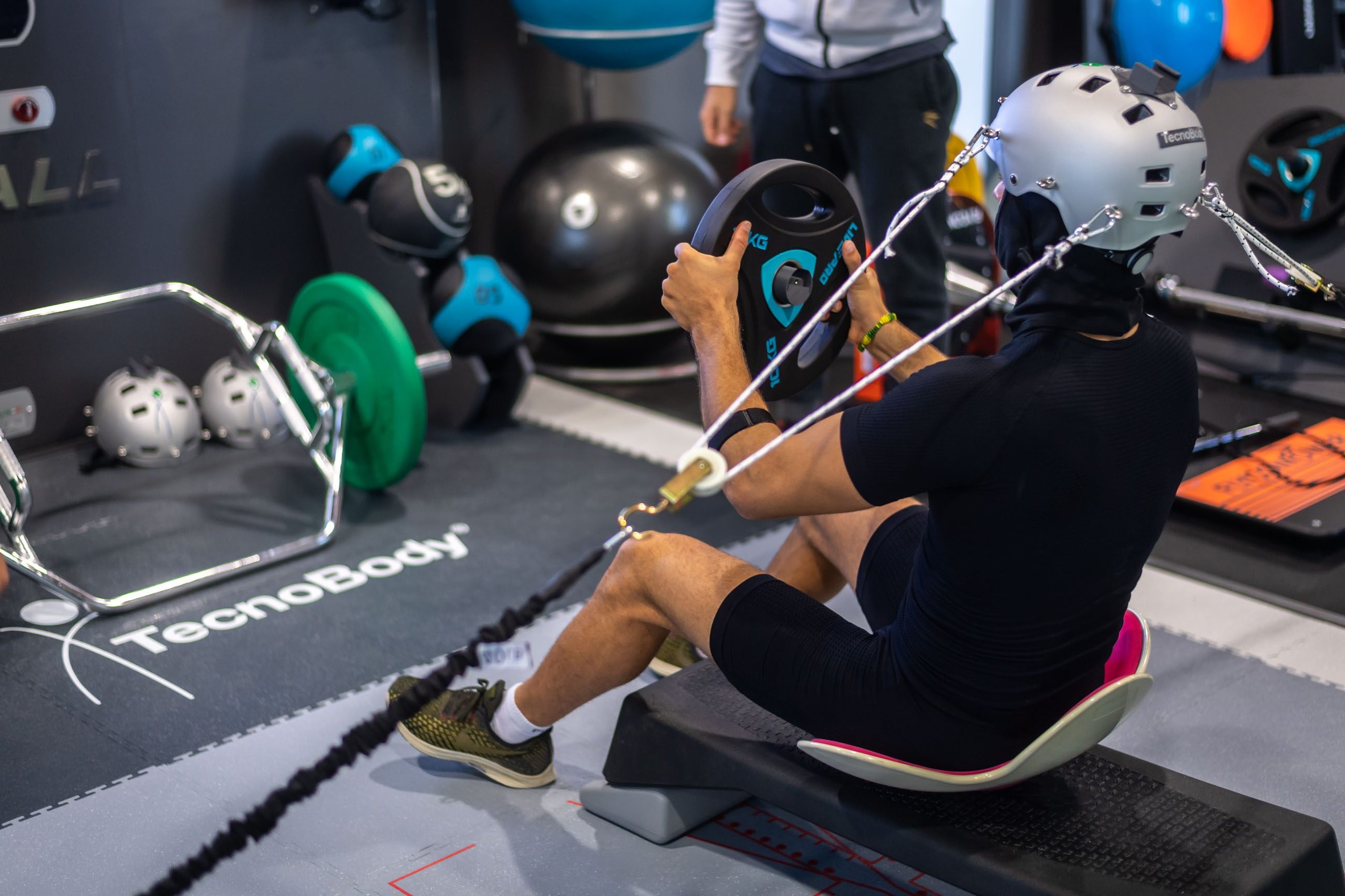 34 Aspiring Racers, One Factory Seat: Inside Squadra Corse'S Talent Pipeline For 2021 5 A driver in training performs a weighted exercise wearing a head-mounted resistance device in a gym