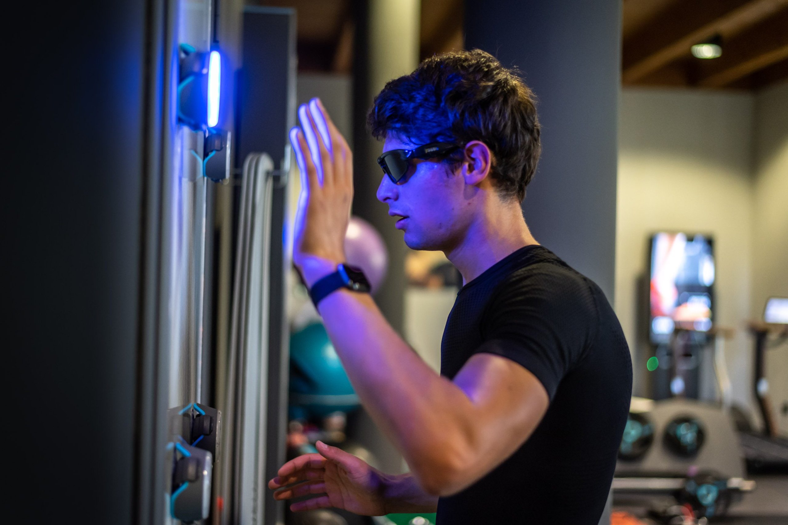34 Aspiring Racers, One Factory Seat: Inside Squadra Corse'S Talent Pipeline For 2021 7 A young driver trains with a glowing blue reaction-time apparatus in a gym setting