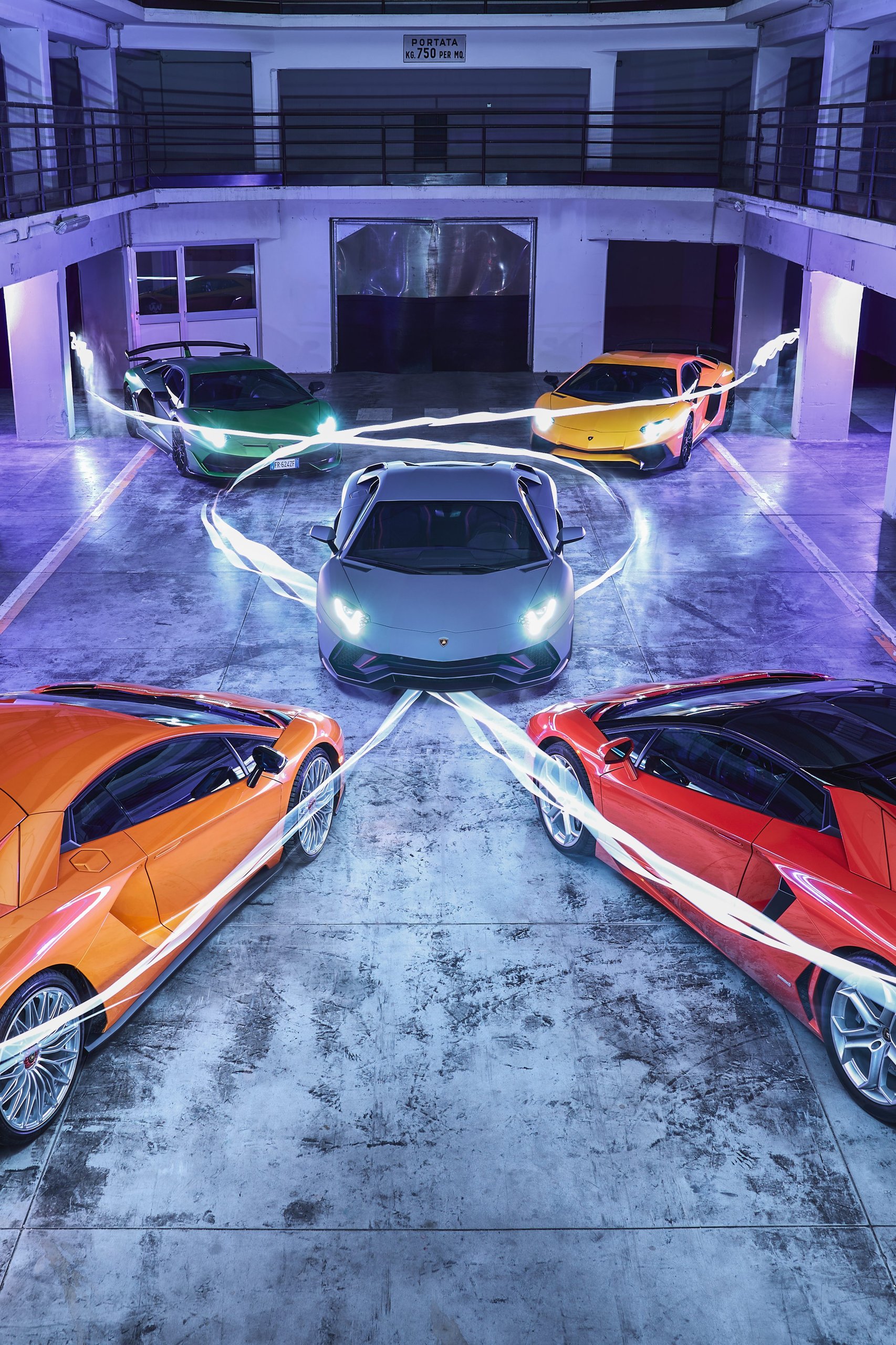 The Last Pure V12 Lamborghini Rolled Off The Line In Light Blue, And Nothing Will Replace What It Represented 5 Five lamborghini aventadors of various colors arranged in a circular pattern in an underground garage
