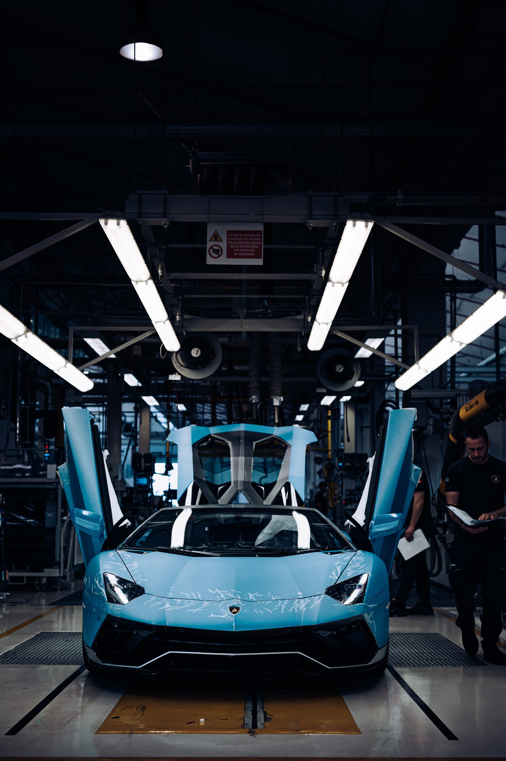 The Last Pure V12 Lamborghini Rolled Off The Line In Light Blue, And Nothing Will Replace What It Represented 11 Light blue lamborghini aventador ultimae with scissor doors open on the assembly line