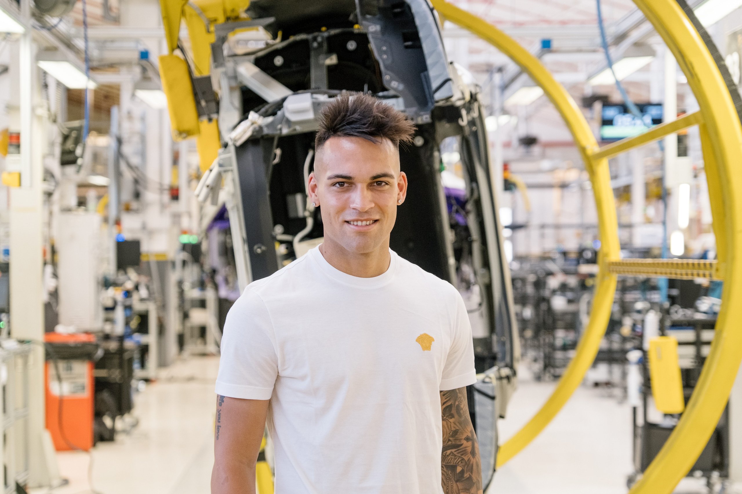 Inside Lautaro Martinez'S Bespoke Urus Configuration At Lamborghini'S Sant'Agata Factory 9 Lautaro martinez smiling in the lamborghini factory with a partially assembled vehicle frame visible behind him