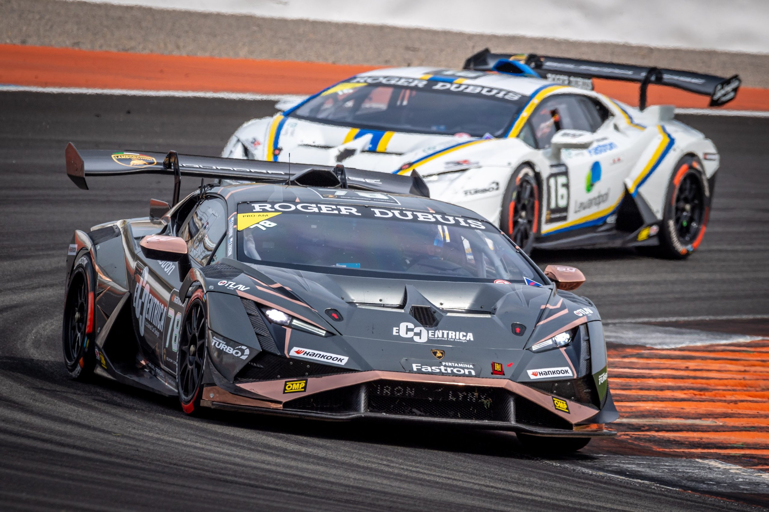 Two lamborghini huracán super trofeo evo2 race cars battle closely on track in valencia