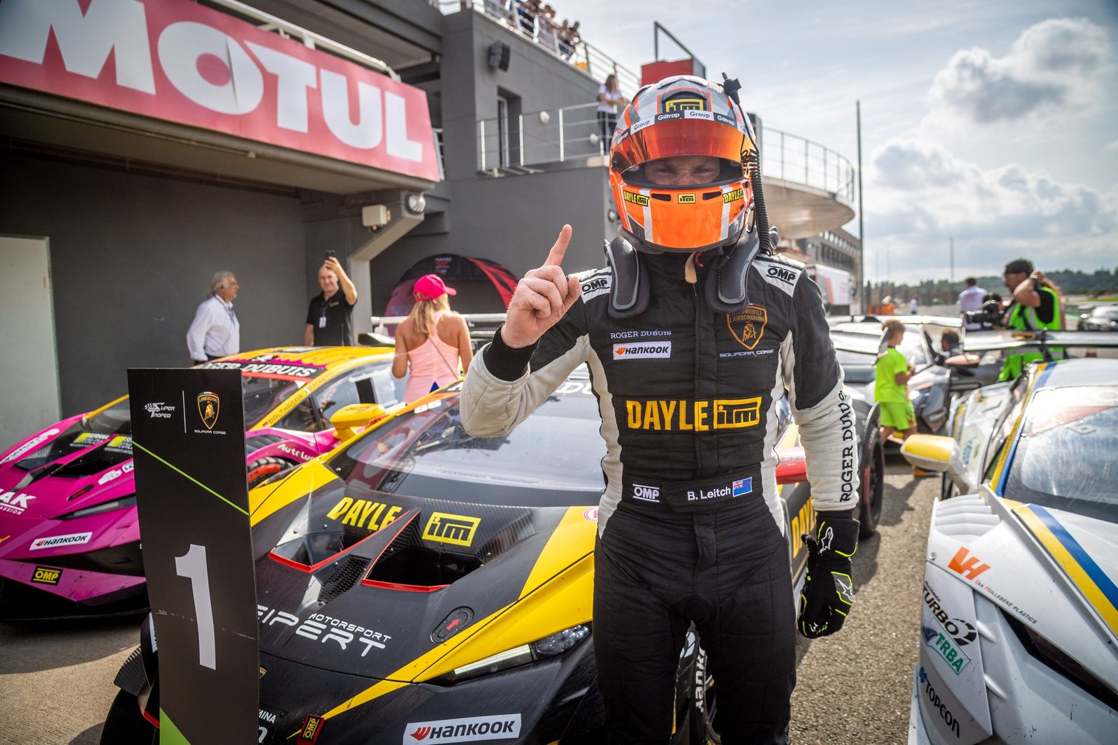 Brendon Leitch points skyward in front of his yellow and black Lamborghini Huracán Super Trofeo EVO2 after winning in Valencia