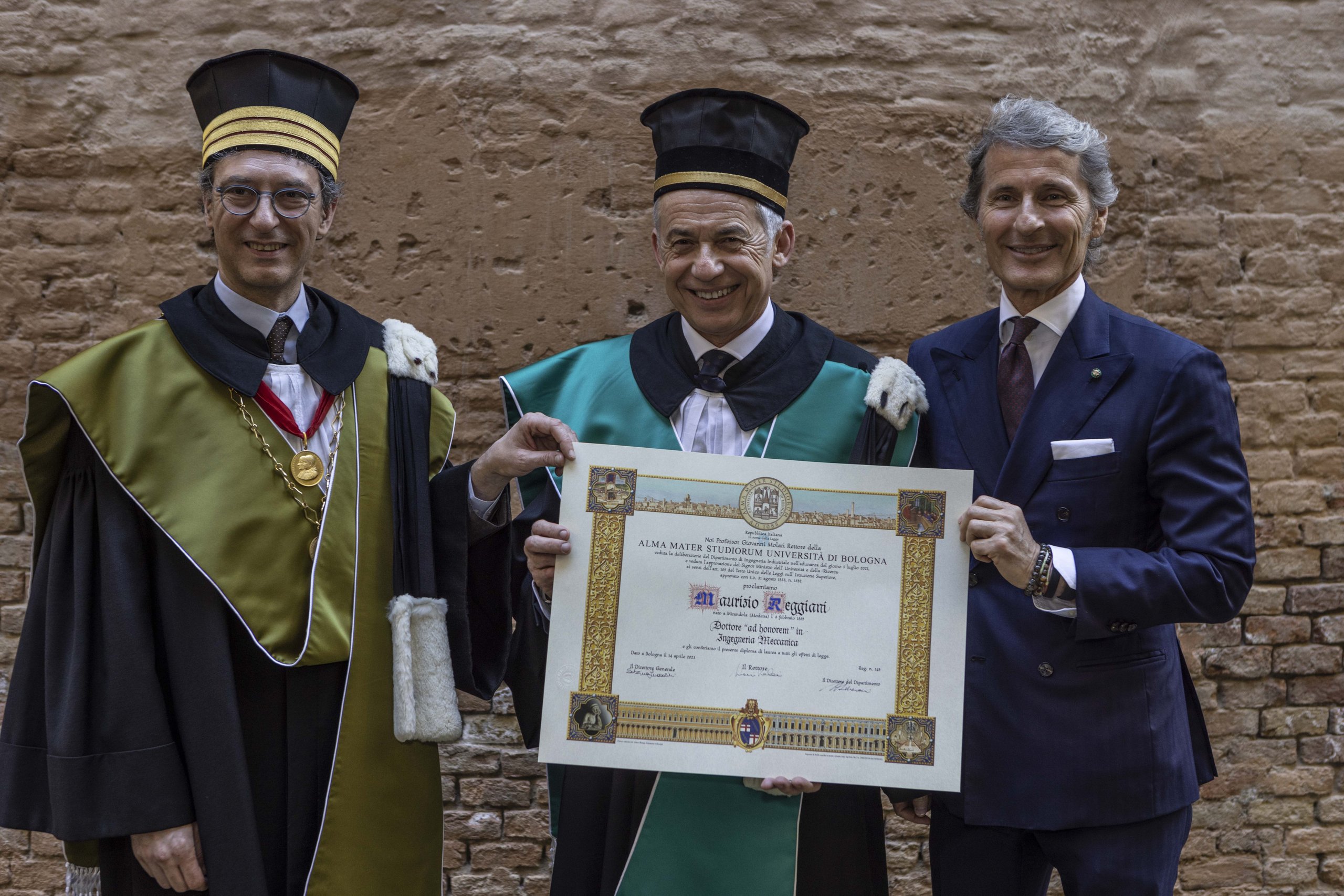 The Engineer Behind 160 Patents And Five Iconic Lamborghinis Earns Bologna'S Rarest Honor 3 Maurizio reggiani displaying his honorary degree certificate outdoors with university faculty
