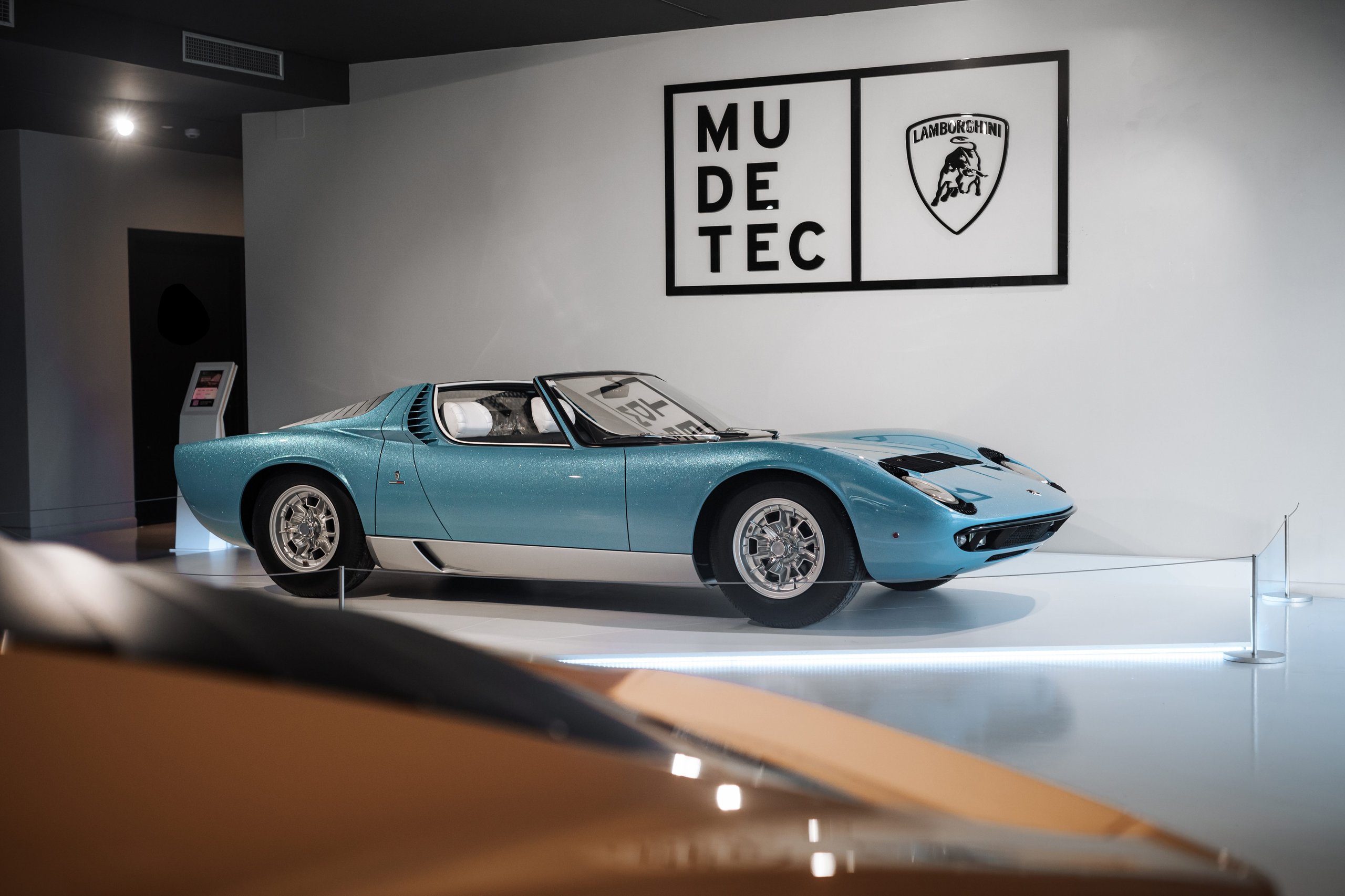 The 1968 Miura Roadster Returns To Mudetec, And Its Design Dna Lives In The Aventador Ultimae'S Final Bow 3 Front three-quarter view of the light blue metallic 1968 lamborghini miura roadster at the mudetec museum