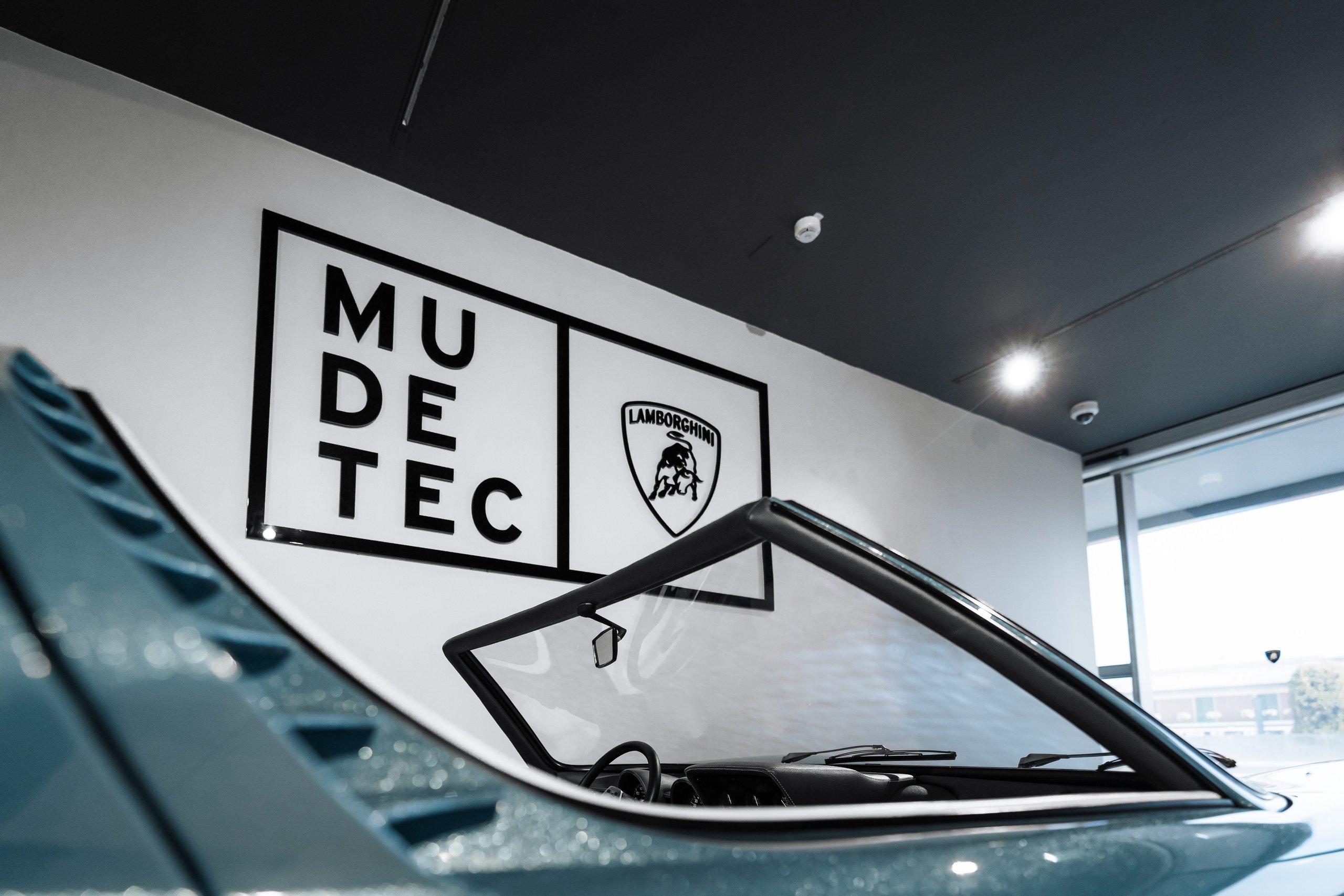 The 1968 Miura Roadster Returns To Mudetec, And Its Design Dna Lives In The Aventador Ultimae'S Final Bow 7 Overhead view of the lamborghini miura roadster cockpit and windshield at mudetec, with the museum sign visible in the background