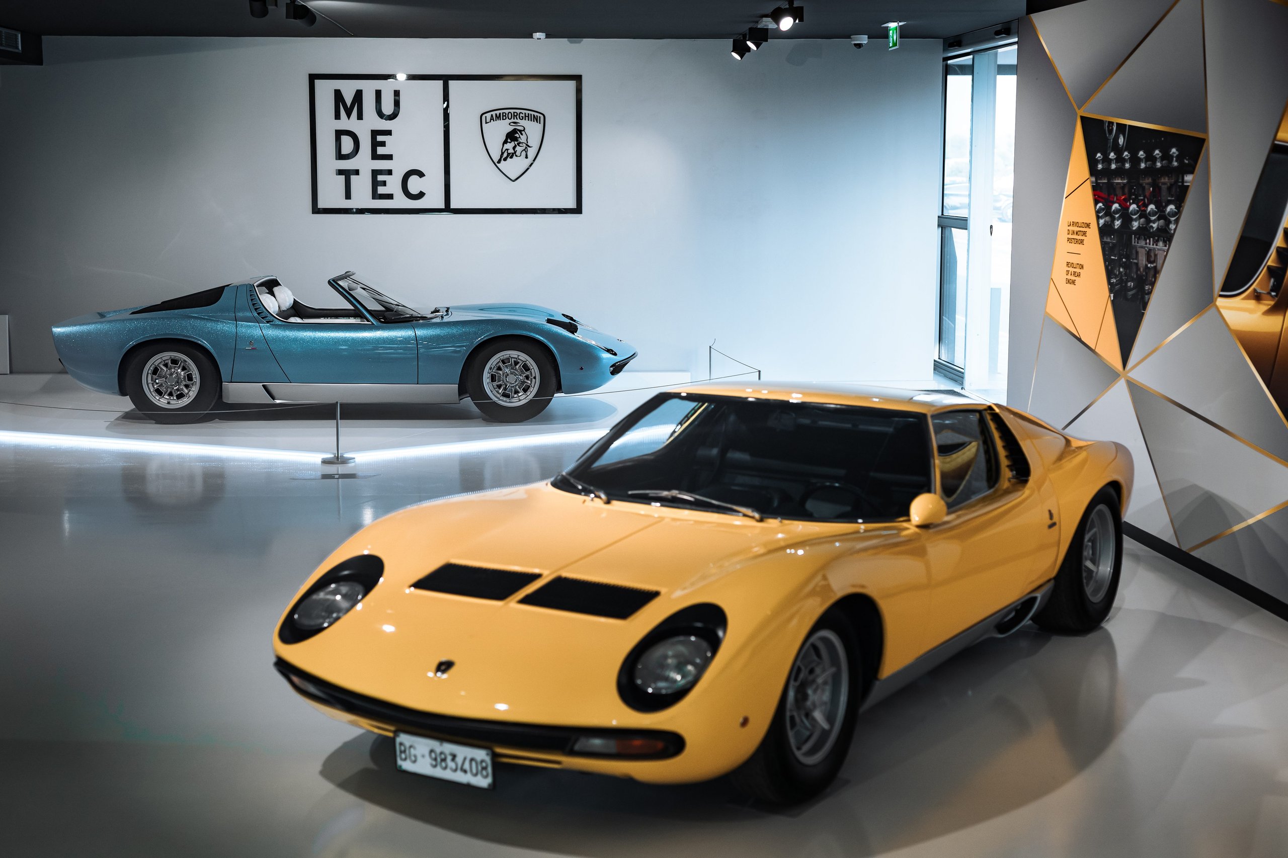 The 1968 Miura Roadster Returns To Mudetec, And Its Design Dna Lives In The Aventador Ultimae'S Final Bow 5 Two lamborghini miura models on display at mudetec: the light blue roadster and a yellow coupe side by side