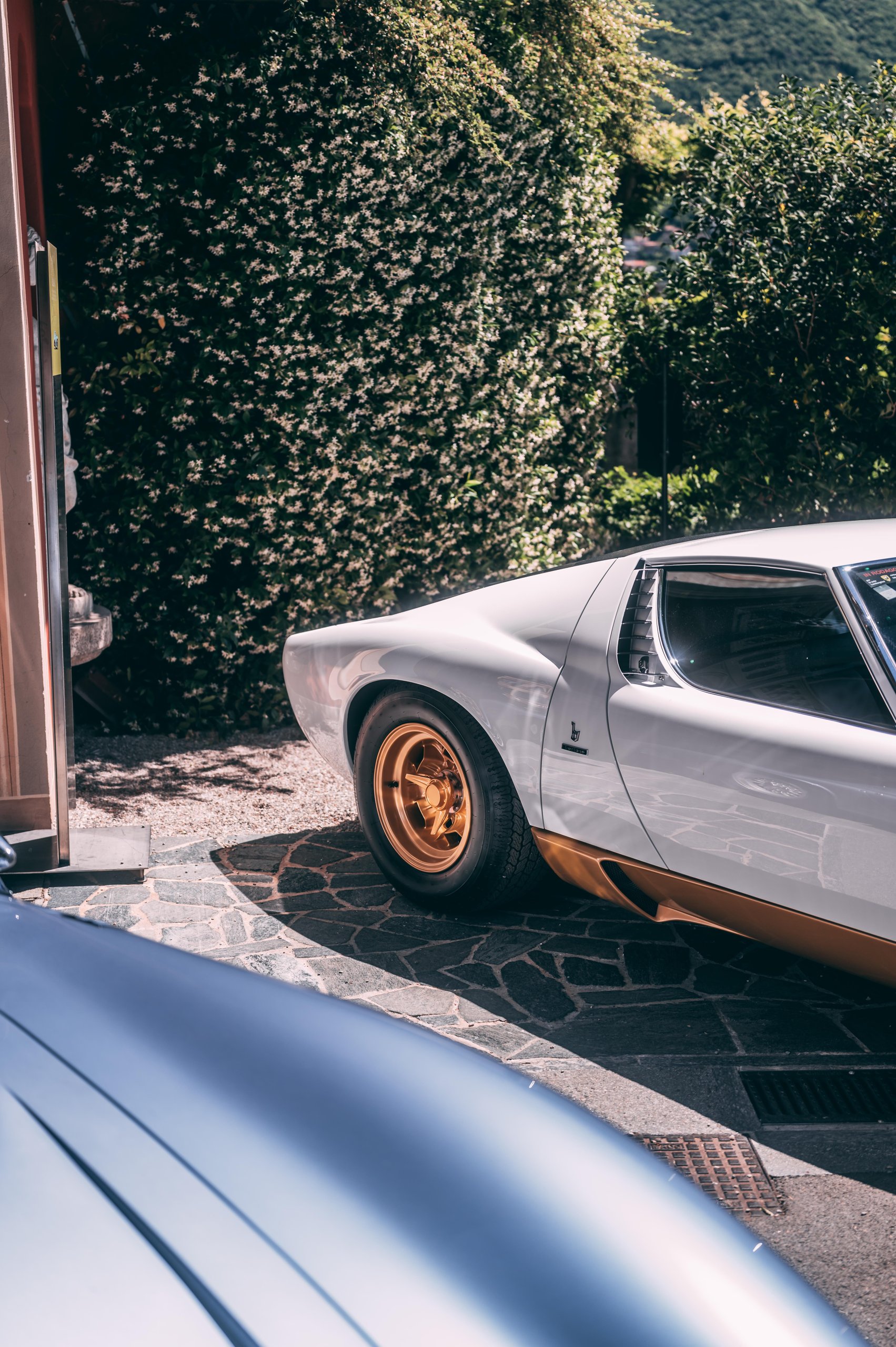 A 1971 Miura Sv Just Won At Villa D'Este, And Its 60Th Anniversary Timing Could Not Be Better 3 Close-up of the rear quarter of a white lamborghini miura sv showing gold wheels and side air intake
