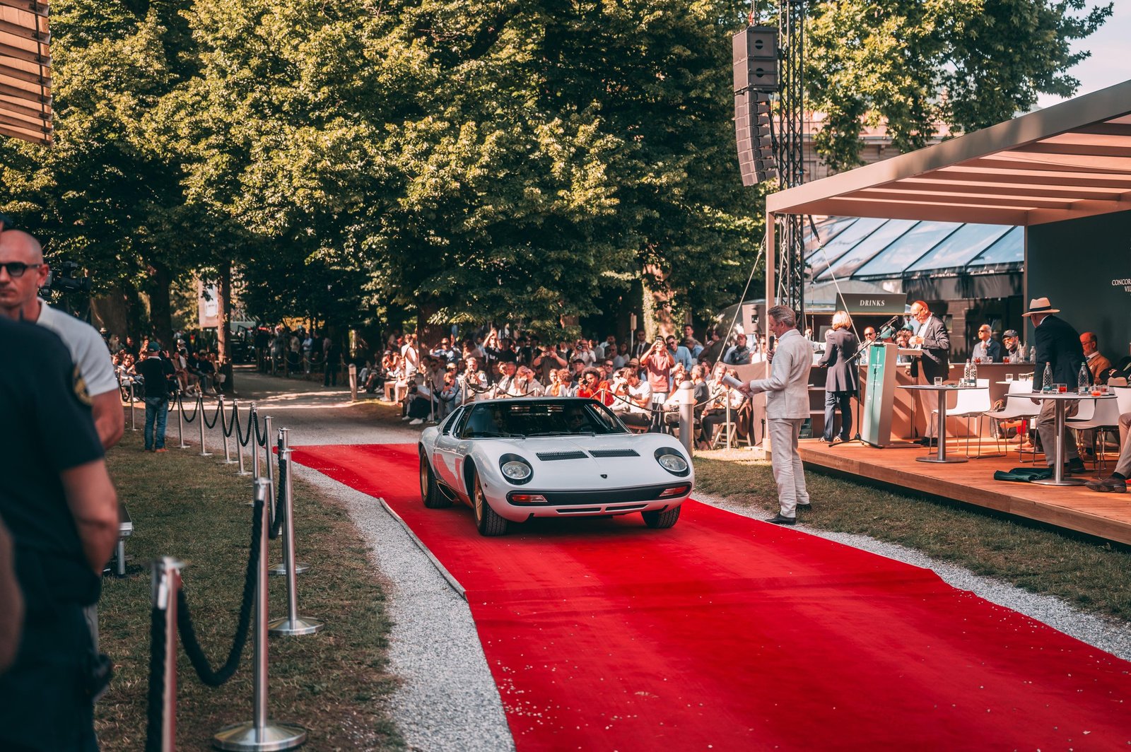White 1971 Lamborghini Miura SV driving on the red carpet at the 2026 Concorso d'Eleganza Villa d'Este