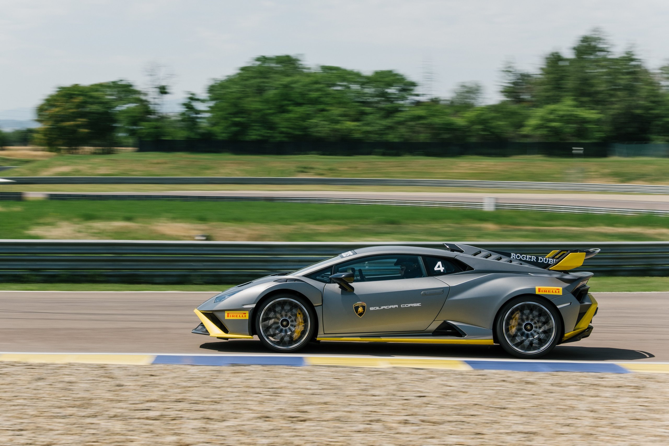 When Muse Visited Sant'Agata, The Huracán Sto Became Their Opening Act 9 Grey lamborghini huracán sto with yellow accents and squadra corse branding speeding on the modena race track