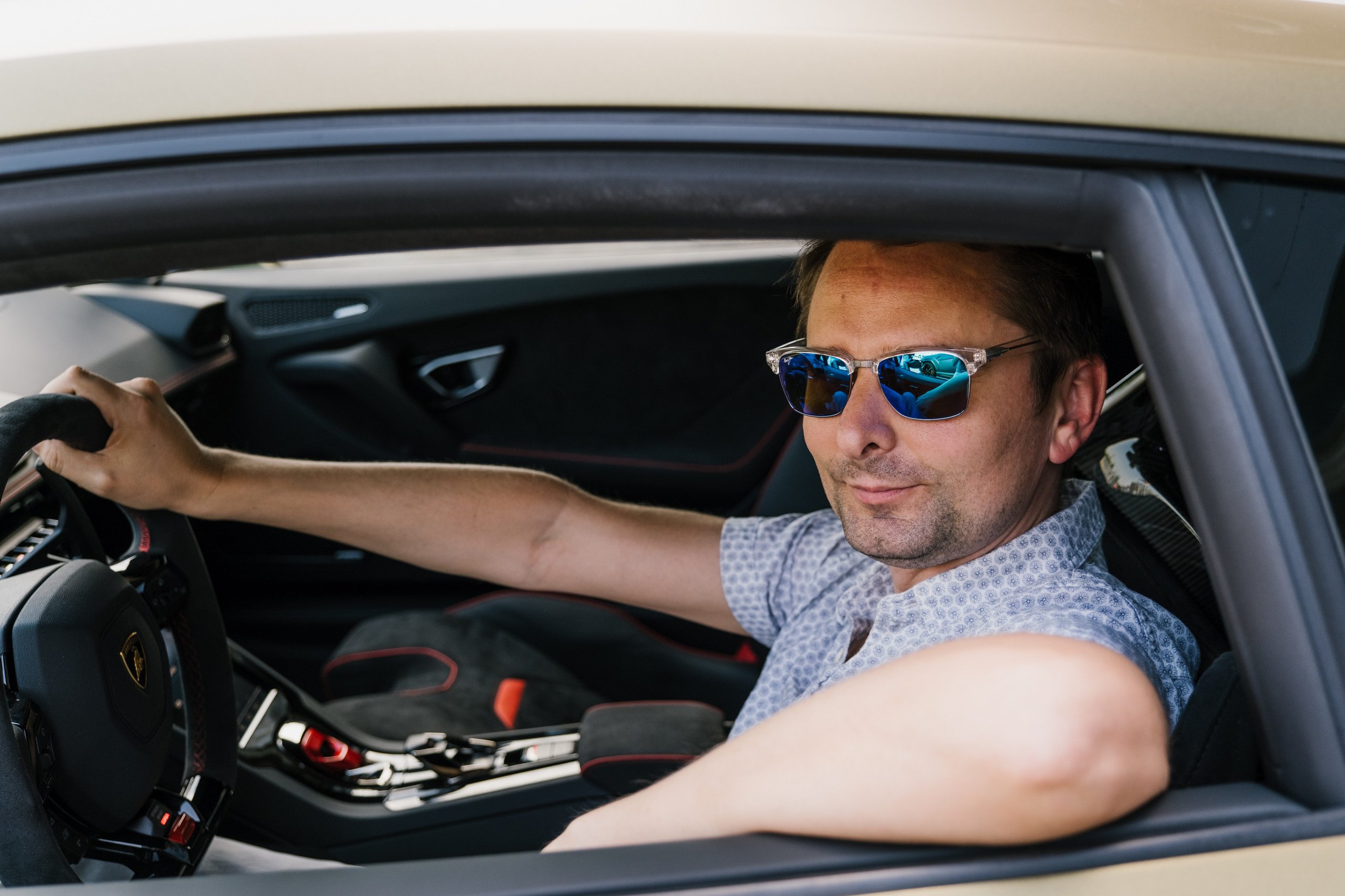 When Muse Visited Sant'Agata, The Huracán Sto Became Their Opening Act 3 Matt bellamy seated in the driver's seat of a lamborghini huracán sto with red and black interior accents and racing-inspired steering wheel