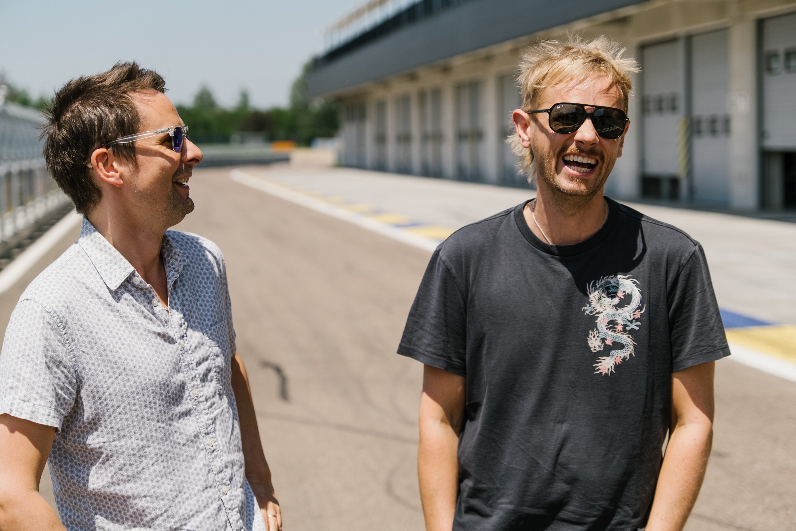 When Muse Visited Sant'Agata, The Huracán Sto Became Their Opening Act 5 Matt bellamy and dom howard laughing together on the race track at modena
