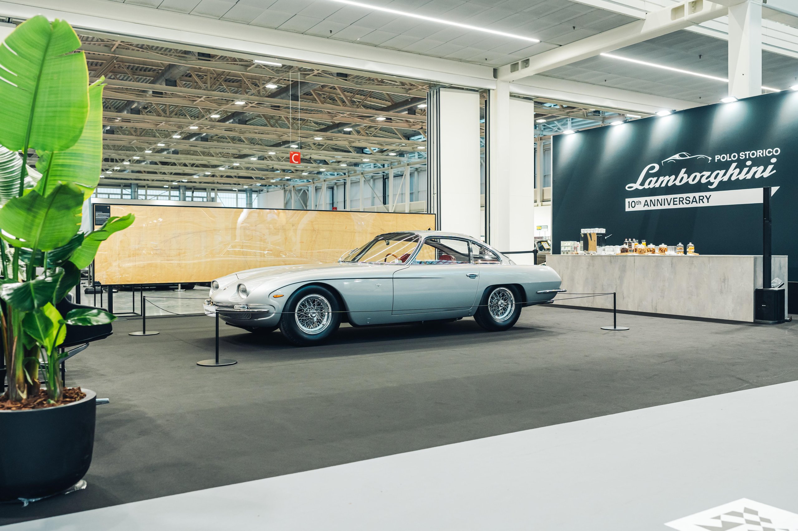 Polo Storico'S Oldest Surviving Lamborghini And A 2026 Miura Tour Signal Where The Brand'S Heritage Strategy Is Heading 3 Silver lamborghini 350 gt displayed on black carpet at indoor exhibition with polo storico 10th anniversary banner