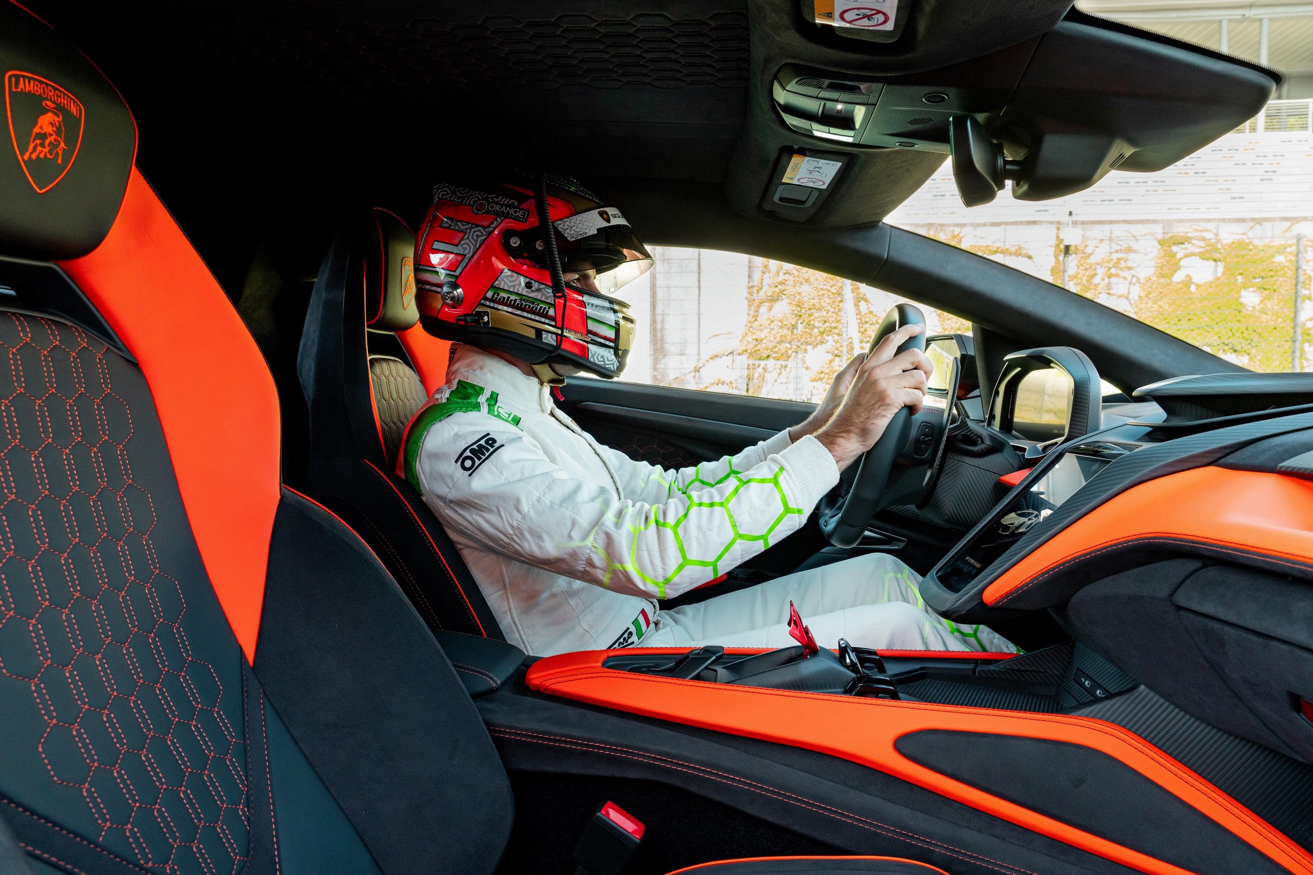Factory Driver Caldarelli Puts The Revuelto Through Its Paces At Vallelunga, And His Verdict Tells Us More Than The Spec Sheet 11 Helmeted driver seated in the revuelto cockpit with hands on steering wheel, digital display and carbon fiber trim visible