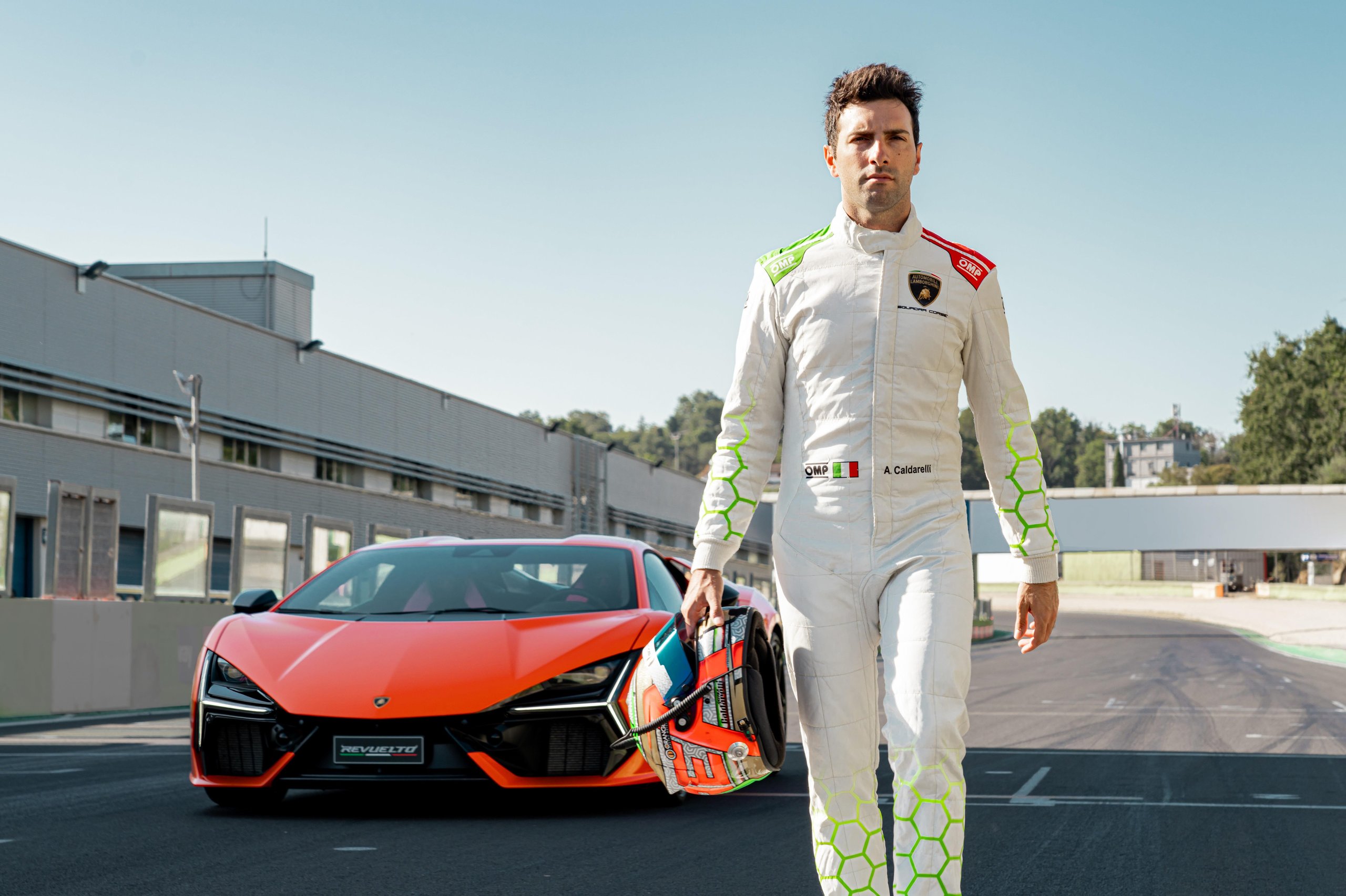 Factory Driver Caldarelli Puts The Revuelto Through Its Paces At Vallelunga, And His Verdict Tells Us More Than The Spec Sheet 3 Andrea caldarelli walking away from an orange lamborghini revuelto on the vallelunga track, holding his helmet