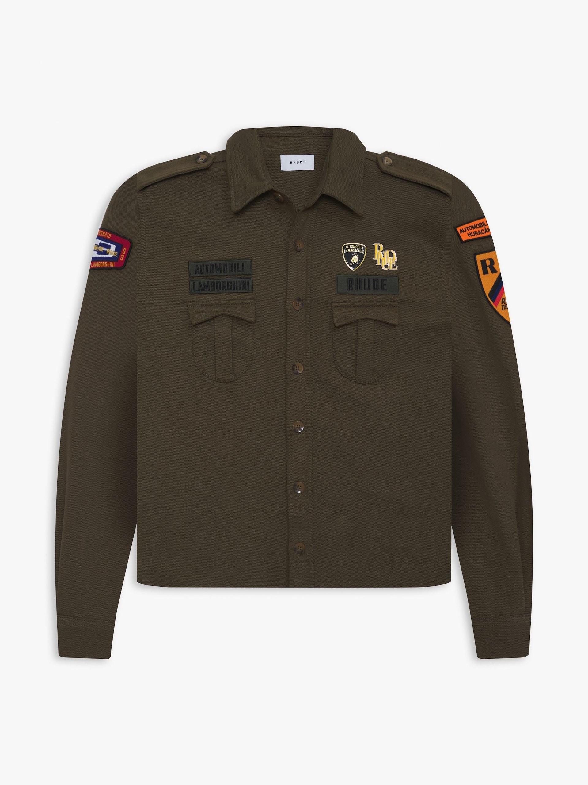 Rhude X Automobili Lamborghini: A Sterrato-Inspired Capsule That Reveals Where The Brand Is Headed 5 Flat lay of the olive green military-style jacket from the rhude x automobili lamborghini collection, featuring multiple embroidered patches and dual branding